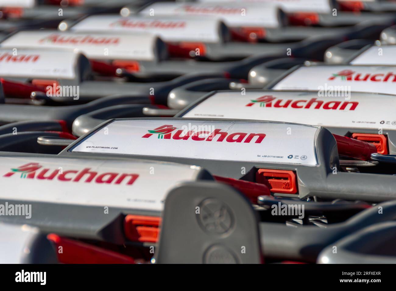 Nahaufnahme einer Reihe von Einkaufswagen mit dem Logo eines Auchan-Geschäfts, eines französischen Unternehmens und einer multinationalen Einzelhandelsgruppe Stockfoto