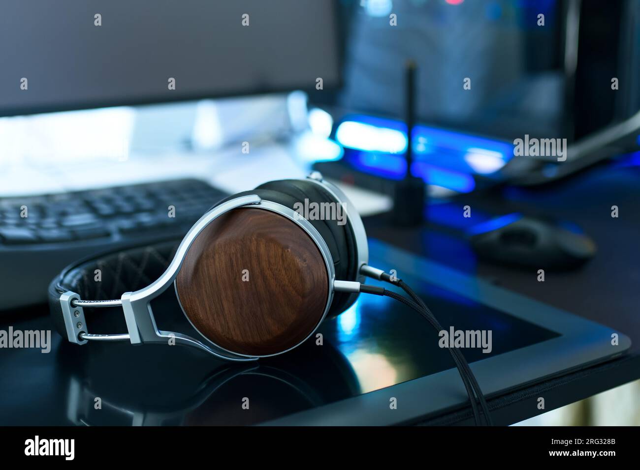 Moderner Computerarbeitsplatz, Schwerpunkt auf Kopfhörern auf dem Zeichnen von Tablets Stockfoto