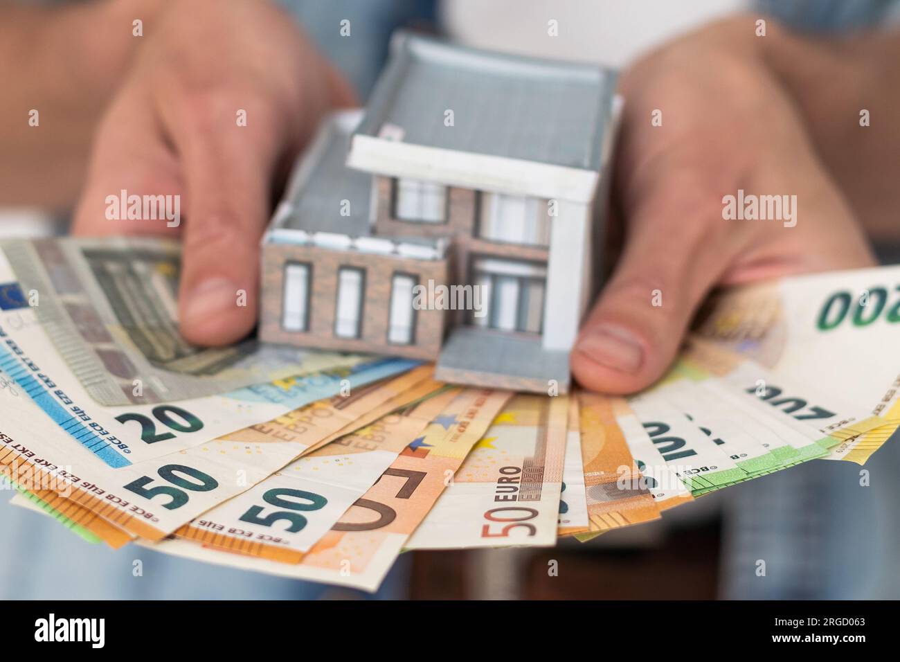 Ein Mann mit weißen Haaren und Geld an ihren Händen an einem sonnigen Tag Stockfoto