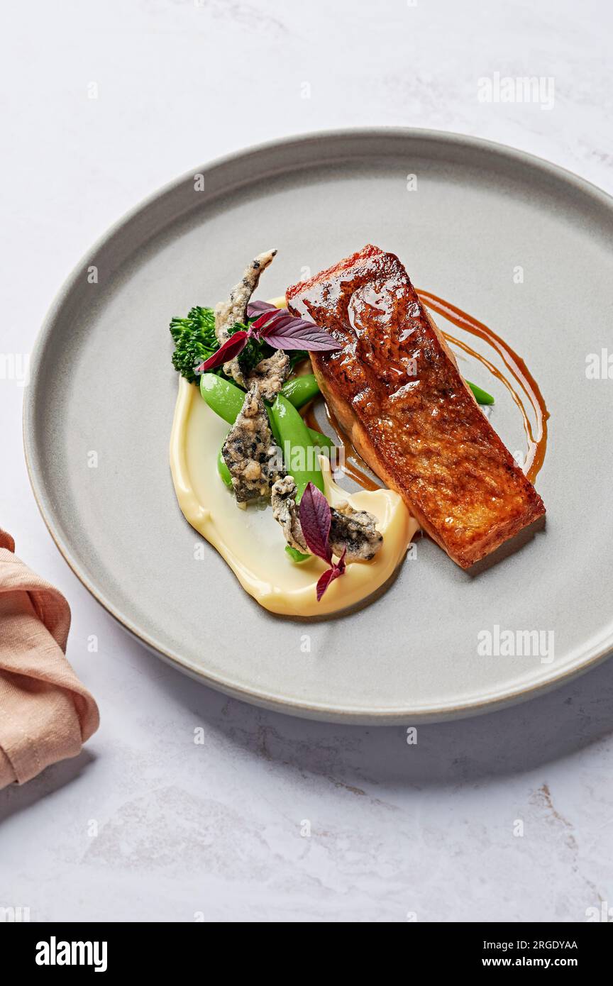 Miso-glasiertes Atlantisches Lachsfilet, Blumenkohlpüree, Zuckererbsen, Brokcolini, knusprige Nori Stockfoto