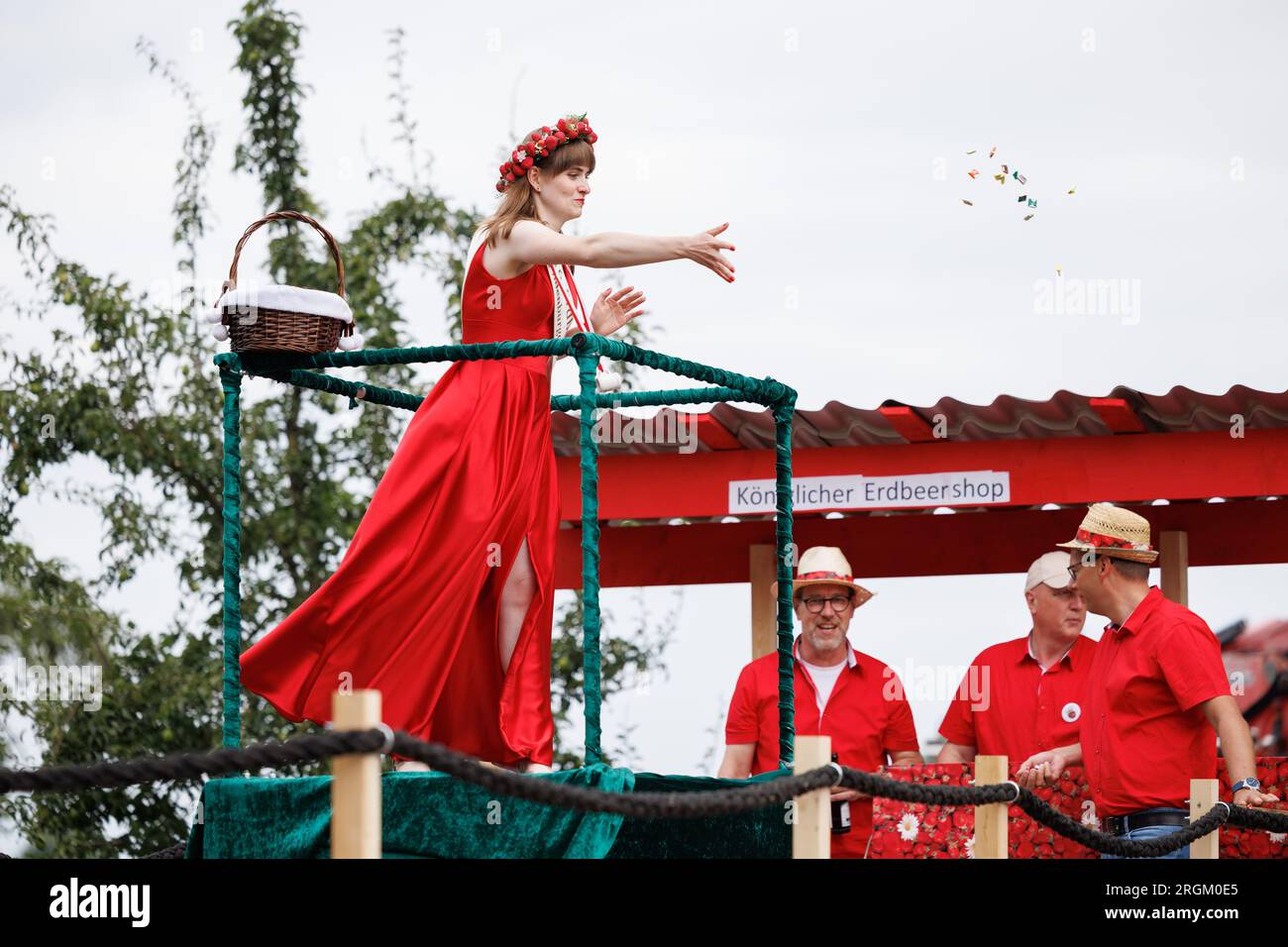 Vechta, Deutschland. 10. Aug. 2023. Die Strawberry Queen aus Oldenburg Münsterland wirft während der Parade am Stoppelmarkt Süßigkeiten in die Menge. Das traditionelle Festival findet seit 725 Jahren statt. Ehrengast bei der Eröffnung ist Lilo Wanders. Kredit: Friso Gentsch/dpa/Alamy Live News Stockfoto