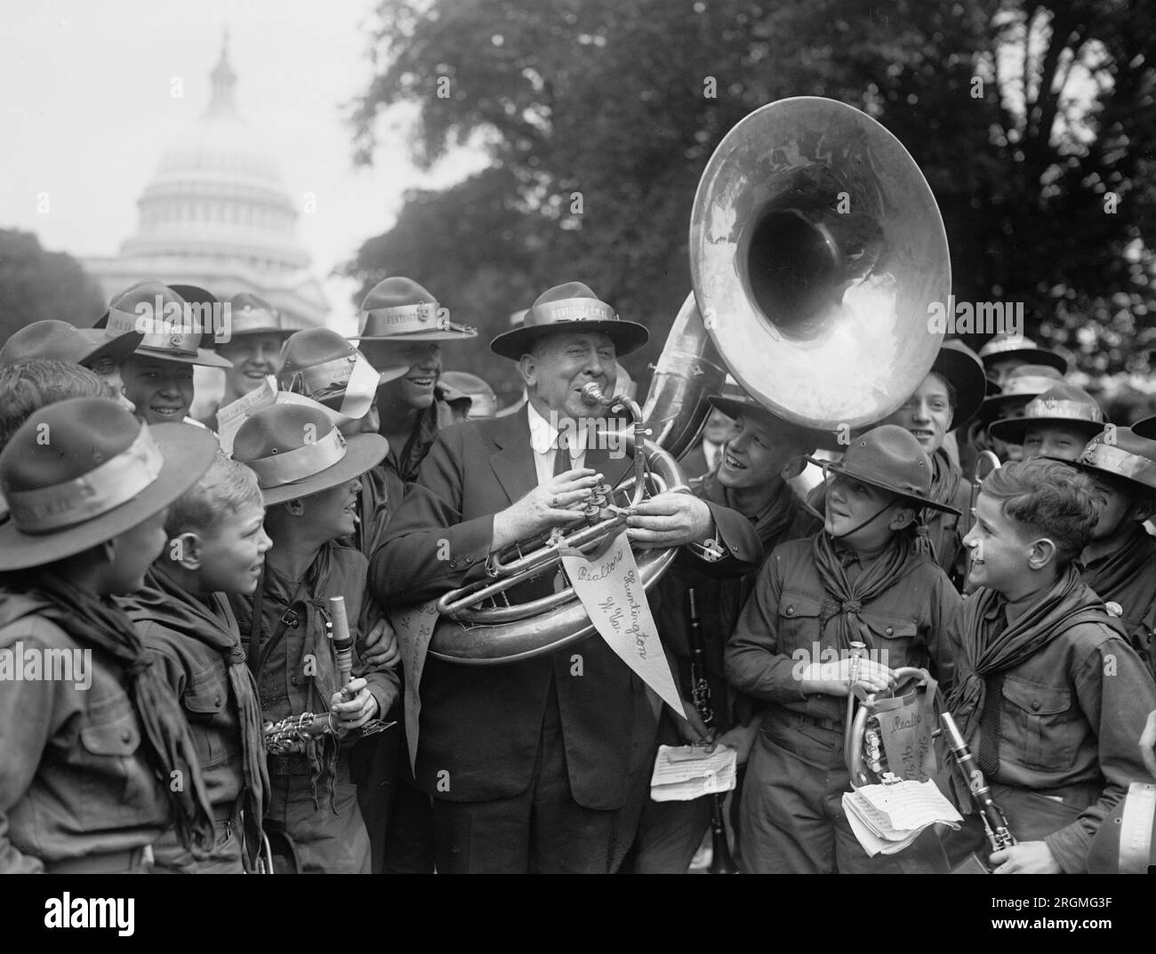 Kongressabgeordneter Geo W. Johnson spielt ein Horn (möglicherweise eine kleine Tuba) für eine Gruppe von Pfadfindern. 1924 Stockfoto