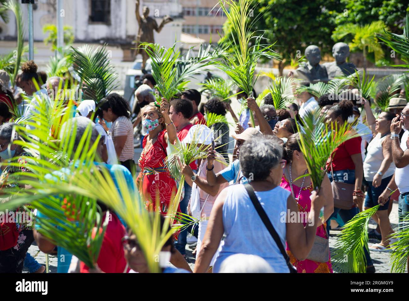 Salvador, Bahia, Brasilien - 02. April 2023: Dutzende von Menschen, die sich an den Katholizismus halten, werden gesehen, wie sie an der Palmensonntagsprozession in der Stadt teilnehmen Stockfoto