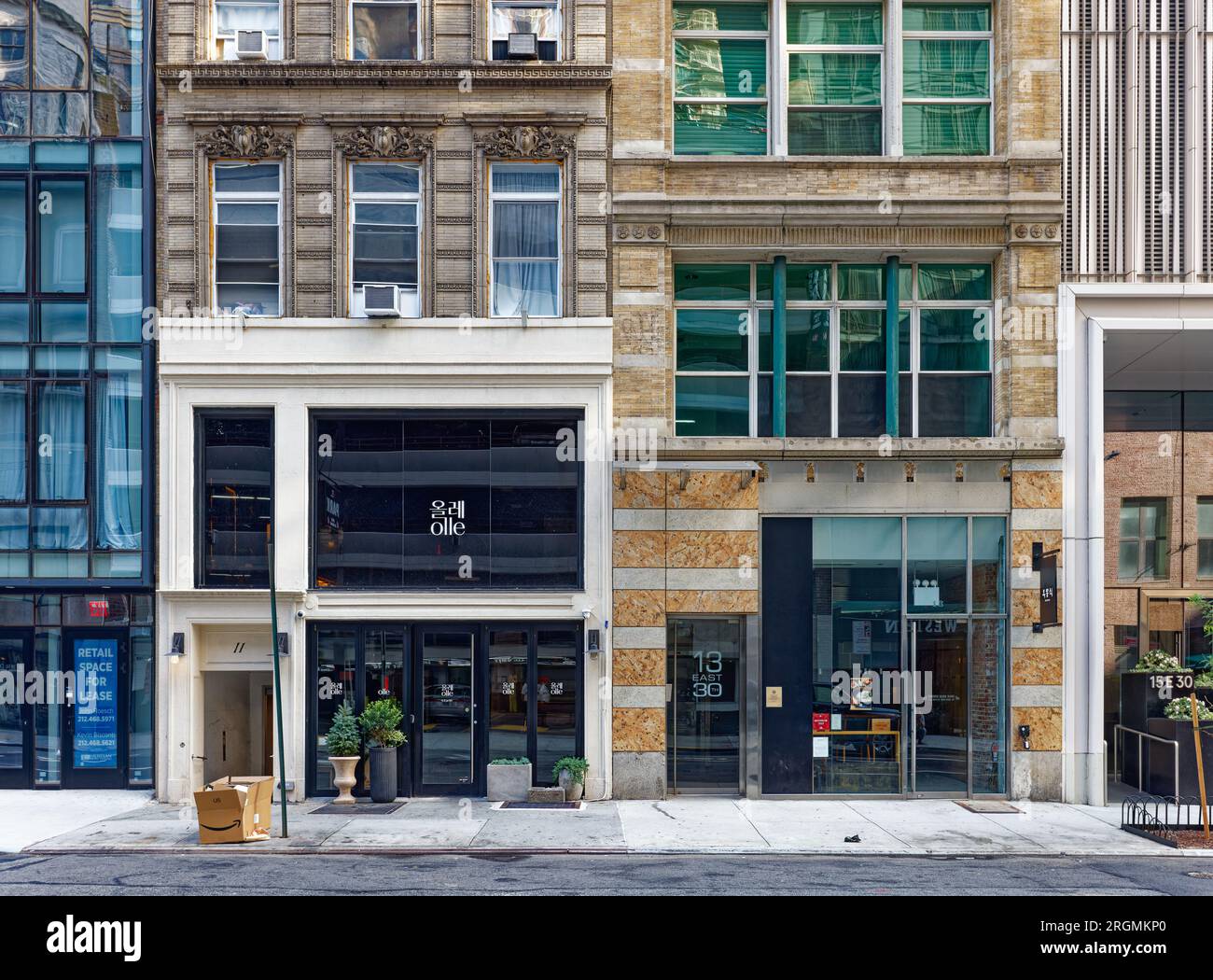 Midtown South: 11 und 13 East 30. Street sind mittelhohe Ziegel- und Terrakotta-Apartmentgebäude, die zwischen zwei Hochhäusern gequetscht sind. Stockfoto