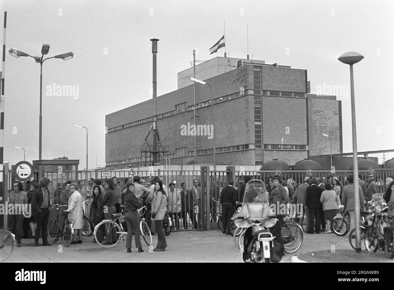 ENKA Company in Breda beschäftigt von Mitarbeitern, Arbeiter an einem geschlossenen Tor mit der Flagge auf Halbmast im Hintergrund ca. September 1972 Stockfoto