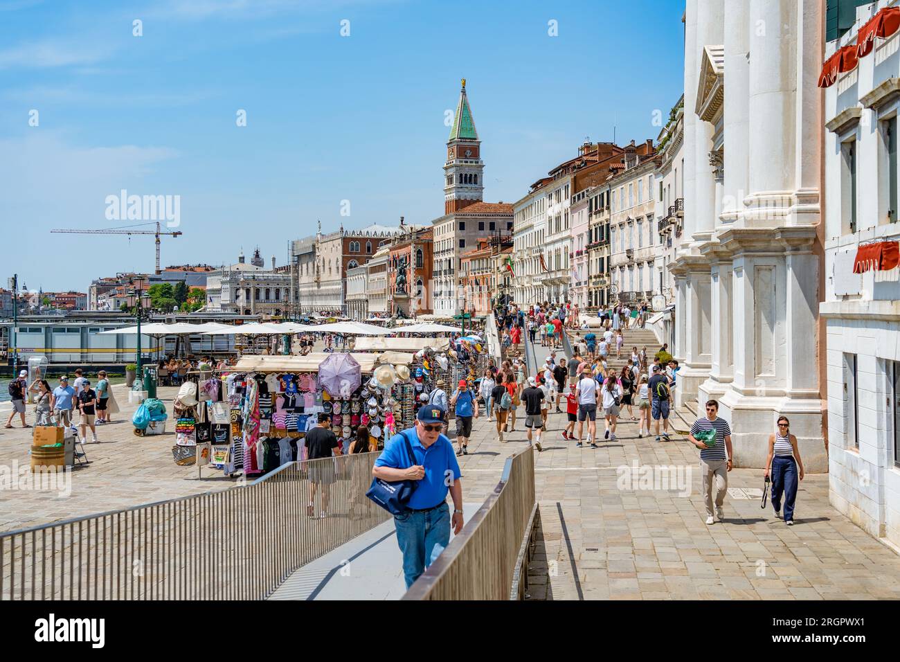 Venedig, Italien - Mai 30 2023: Touristenmassen auf der kopfsteingepflasterten Gasse in der Nähe des Canale Grande in Venedig. Stockfoto