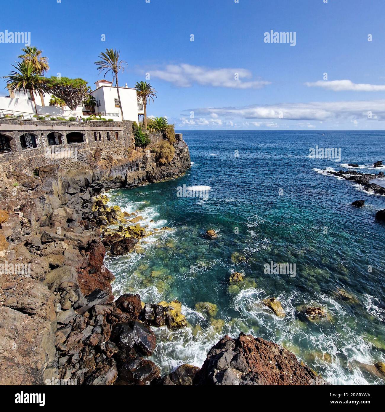 Bei Sonnenaufgang erwacht Puerto de la Cruz mit der sanften Umarmung der Morgensonne. Die Stadt, immer noch in den Überresten der Nacht eingewickelt, beginnt zu schwingen Stockfoto