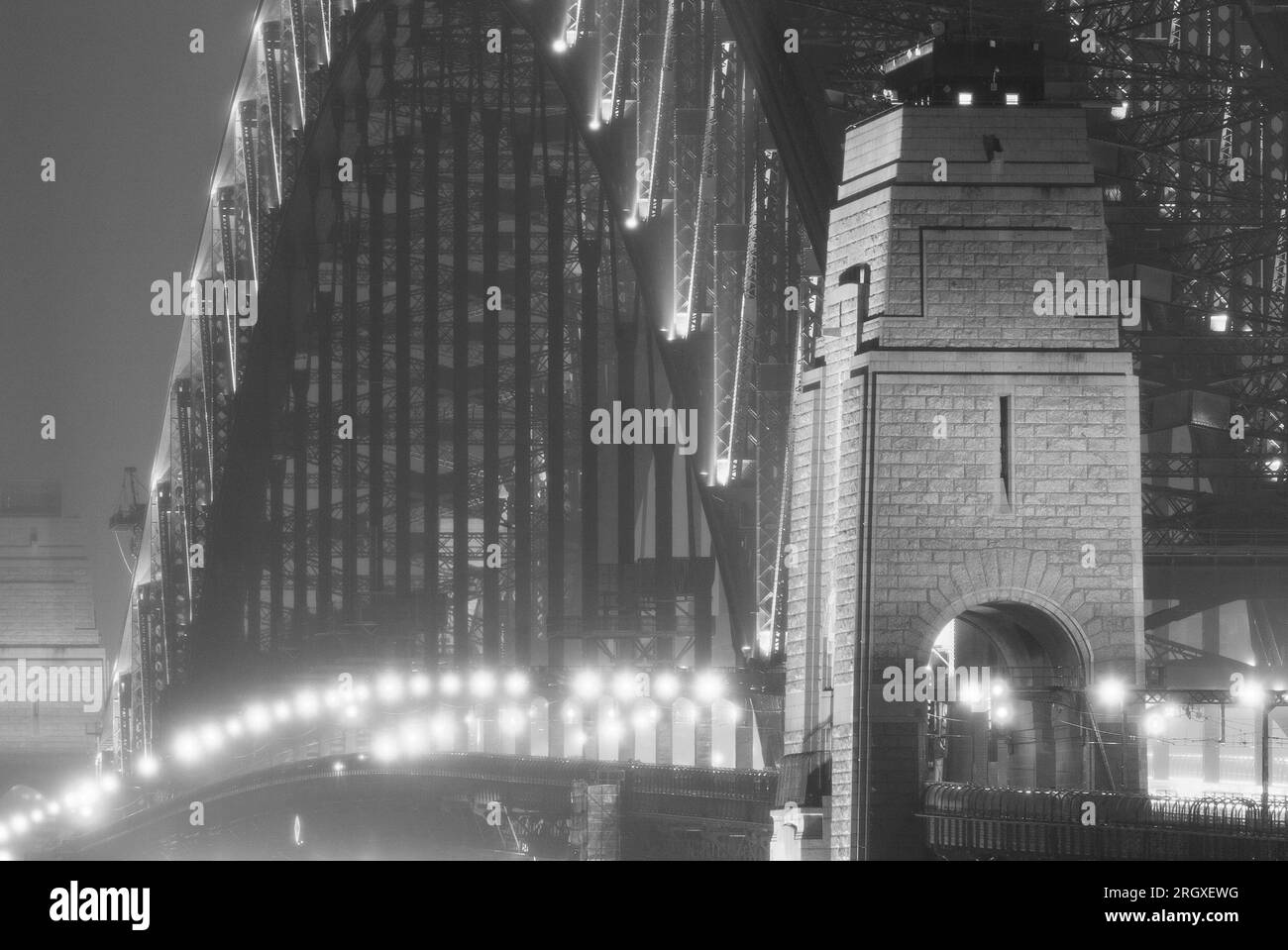 Ein nächtlicher Nebel zieht sich auf der Sydney Harbour Bridge in Sydney, Australien, mit der Lower Fort Street im Vordergrund. Stockfoto