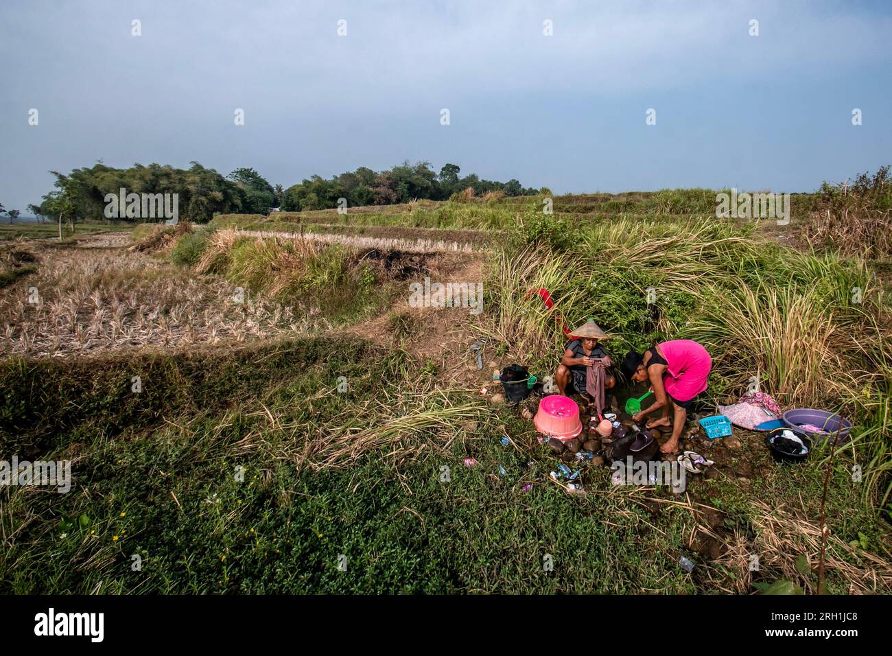 Die Bewohner in Bogor, West Java, Indonesien, waren gezwungen, Infiltrationswasser auf dem Reisfeld zu verwenden, um Kleidung zu waschen am 12. August 2023 Stockfoto