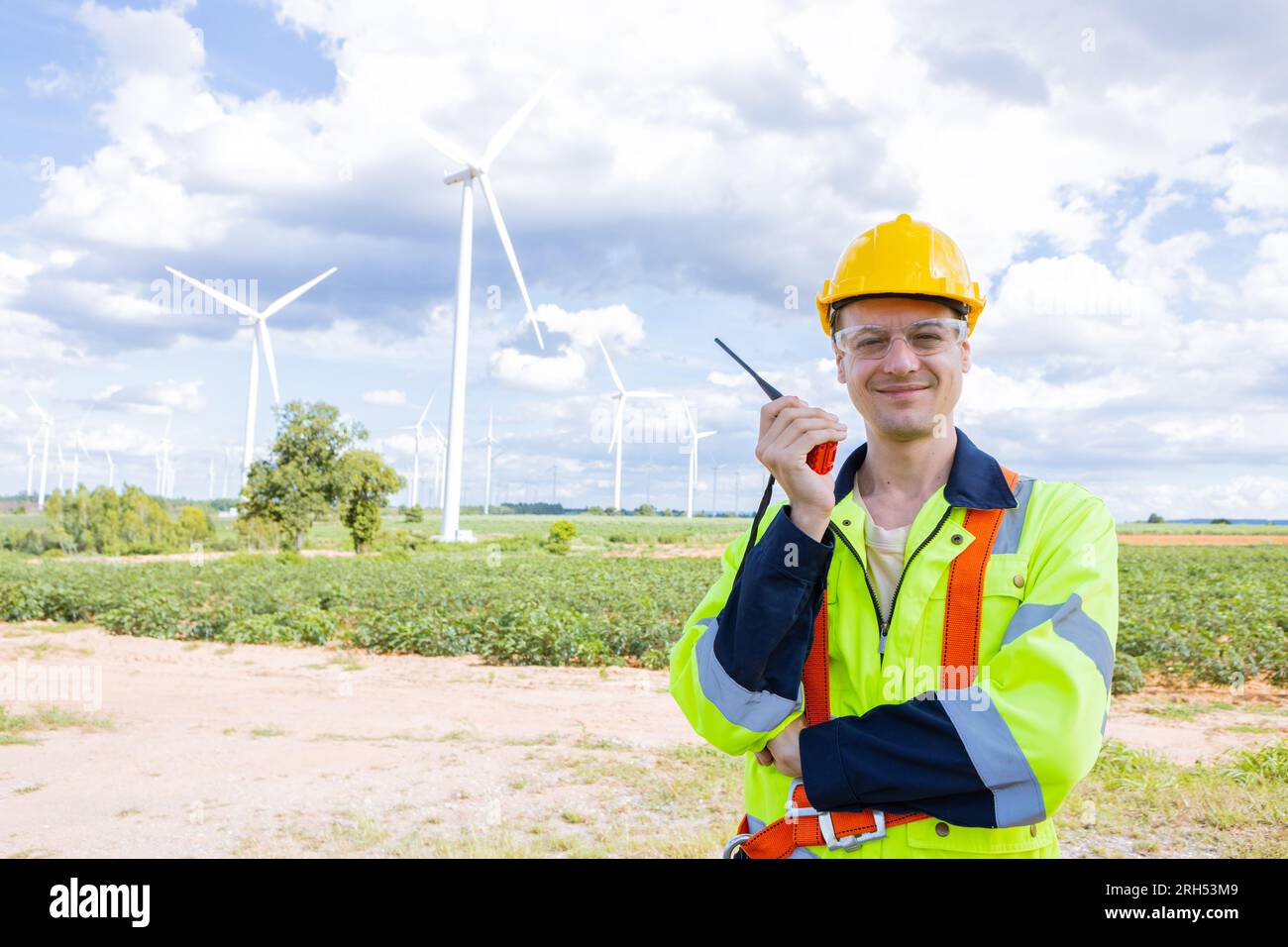 Porträt glücklicher lächelnder Ingenieur professioneller Techniker, männlich, der in Windturbinen am Servicestandort arbeitet Stockfoto