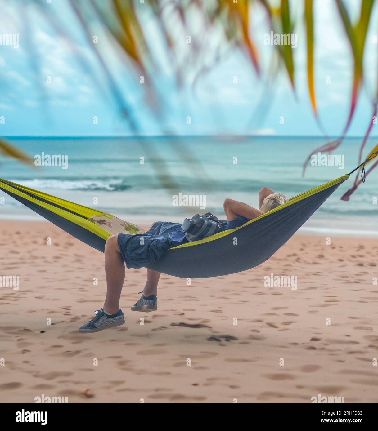 Ein Mann, der Ein Nickerchen in Einer Hängematte am Strand von Hawaii genießt Stockfoto