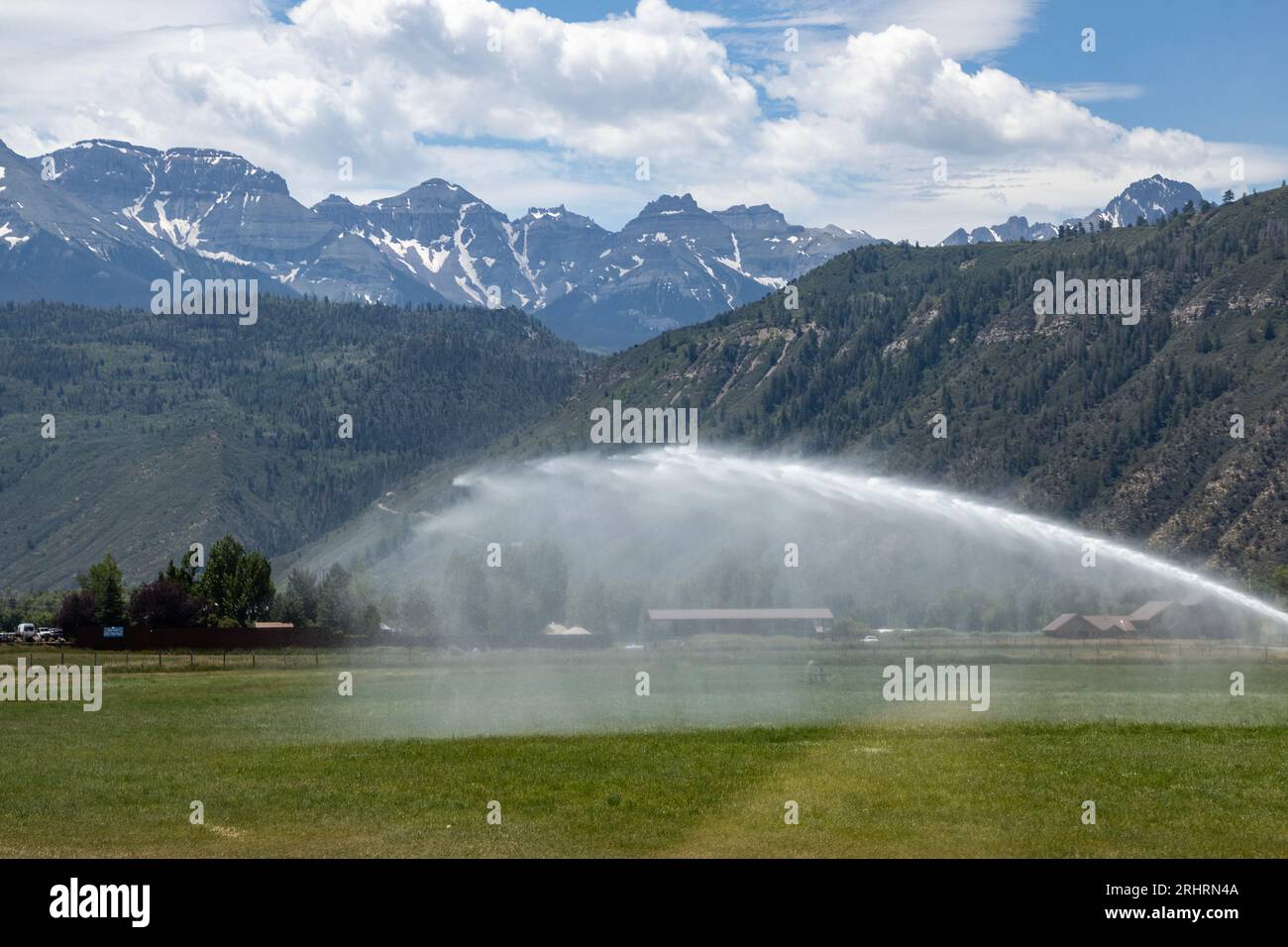Bewässerung des Feldes im Tal zwischen den Bergen in Cclorado. Stockfoto
