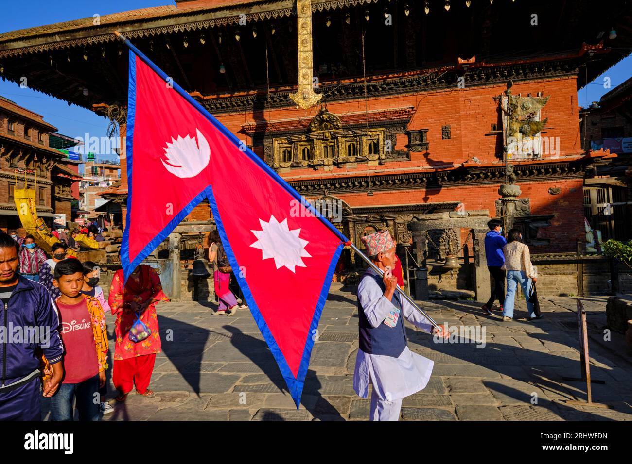 Nepal, Kathmandu-Tal, UNESCO-Weltkulturerbe, Stadt Bhaktapur, Taumadhi Tole Platz, Mann mit der Flagge Nepals Stockfoto