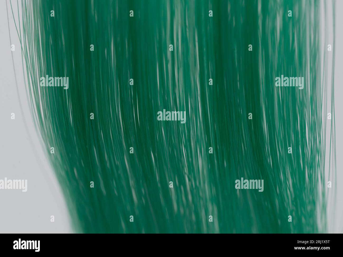 Grüner Haarhintergrund. Nahaufnahme der Haarperücke in grüner Farbe Stockfoto