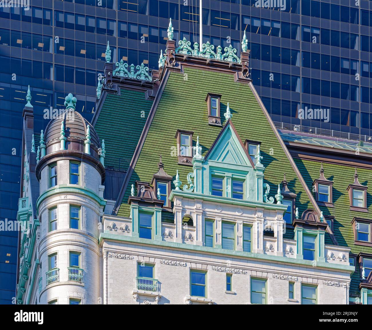 Das Plaza, ein Wahrzeichen von New York City, wurde von Henry J. Hardenbergh im Stil des französischen Renaissance Revival entworfen. Das Solow-Gebäude mit Glasfassade bildet die Kulisse. Stockfoto