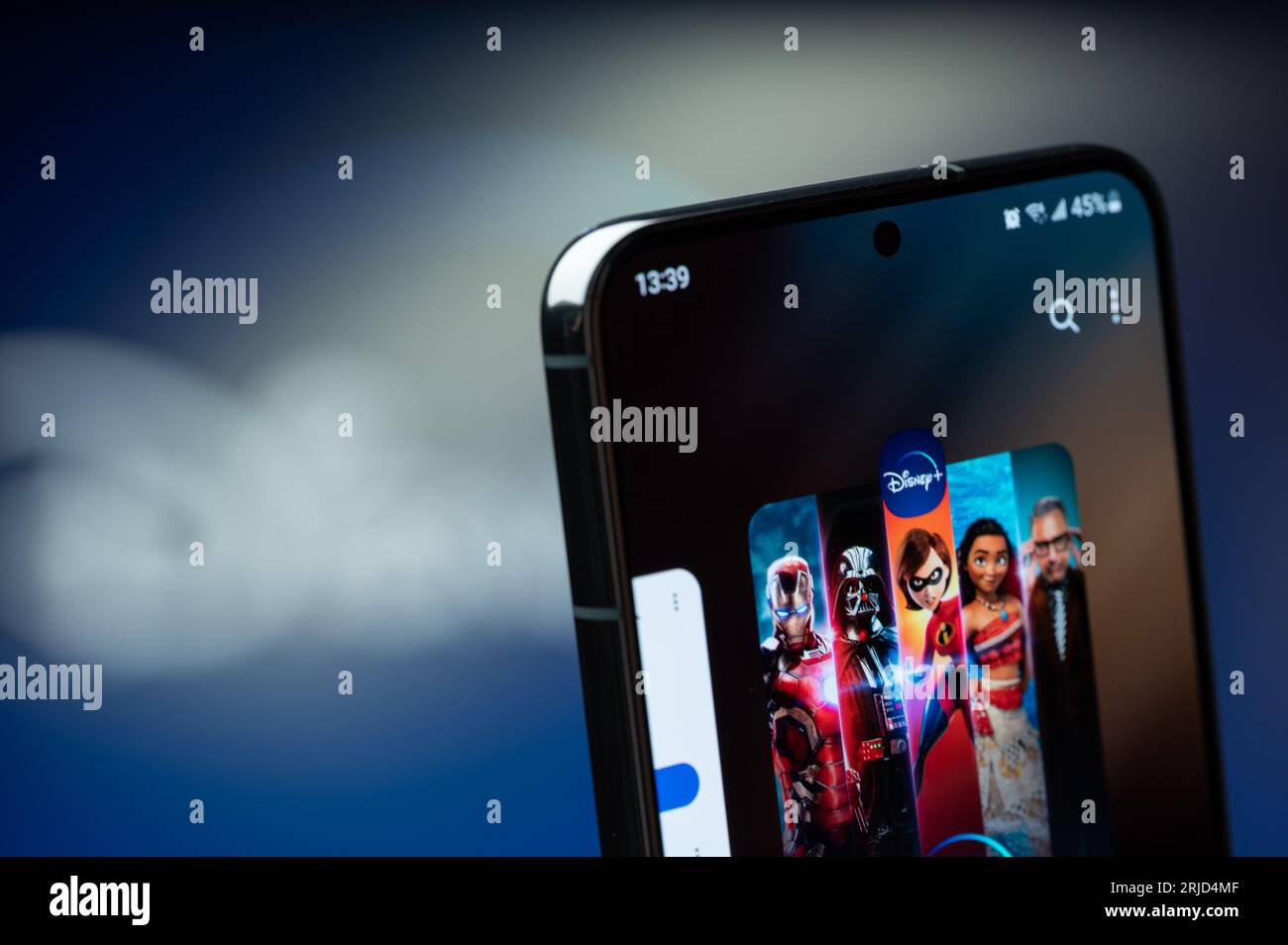 New York, USA - 20. August 2023: Verwendung der Disney plus Service Mobile App auf dem Smartphone-Bildschirm Nahaufnahme mit verschwommenem Logo-Hintergrund Stockfoto