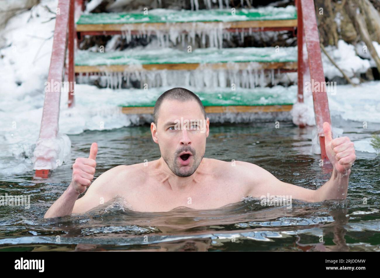 Der Mensch taucht während des Epiphanienfests auf dem Dnipro River in eiskaltes Wasser ein. Januar 2017. Kiew, Ukraine Stockfoto