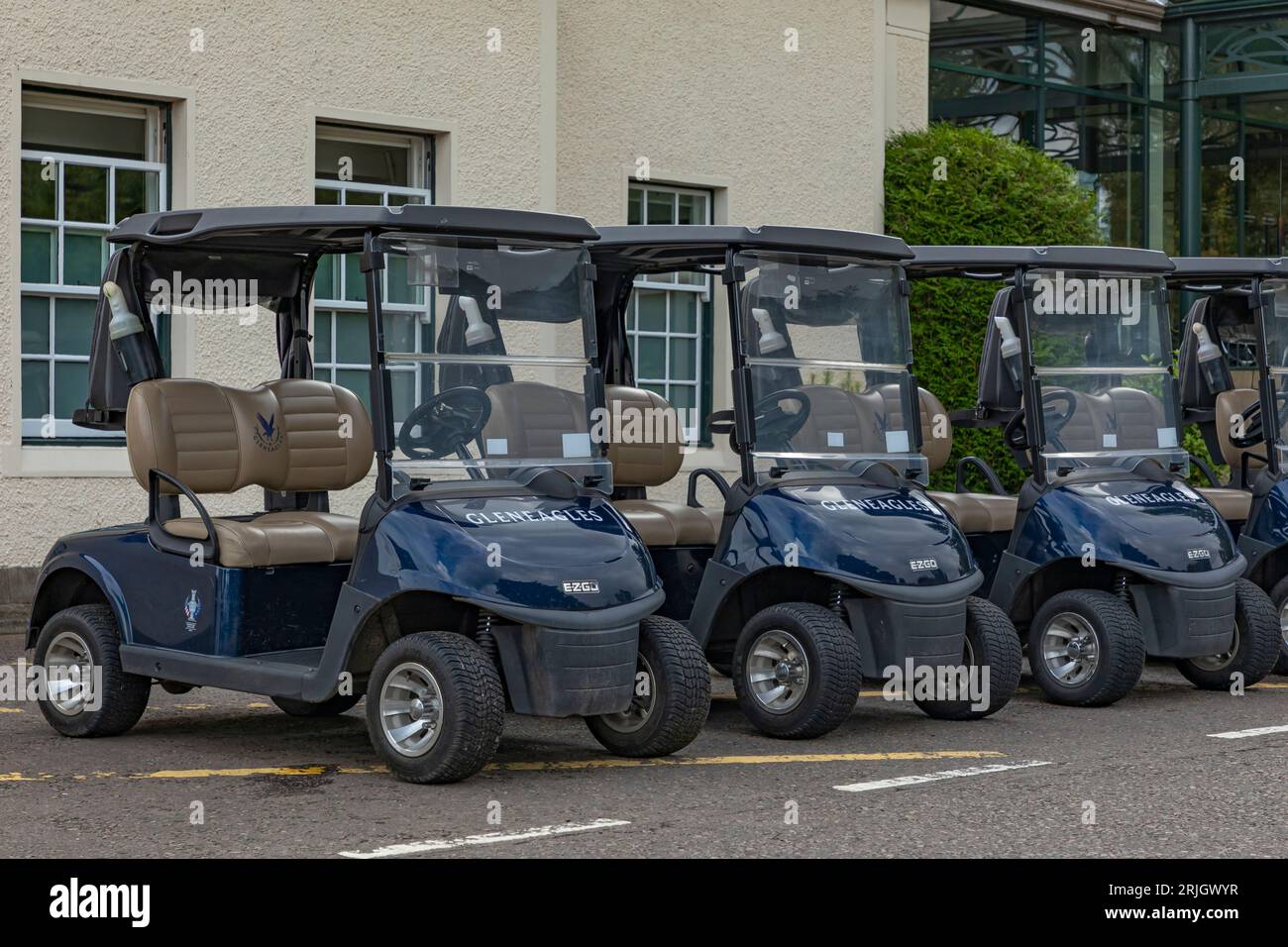 Gleneagles, Schottland, Vereinigtes Königreich - 13. August 2023 - Blaue Golfbuggys auf dem Gleneagles Golfplatz in einer Reihe geparkt Stockfoto