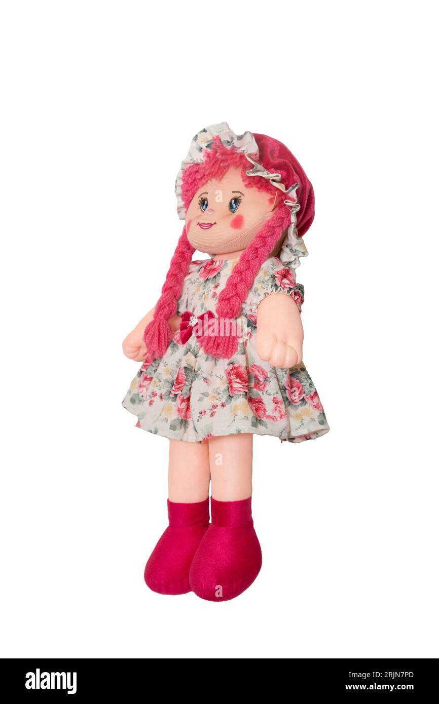 Eine entzückende handgefertigte Puppe mit pinkfarbenen Zopfmustern und einem Blumenkleid Stockfoto