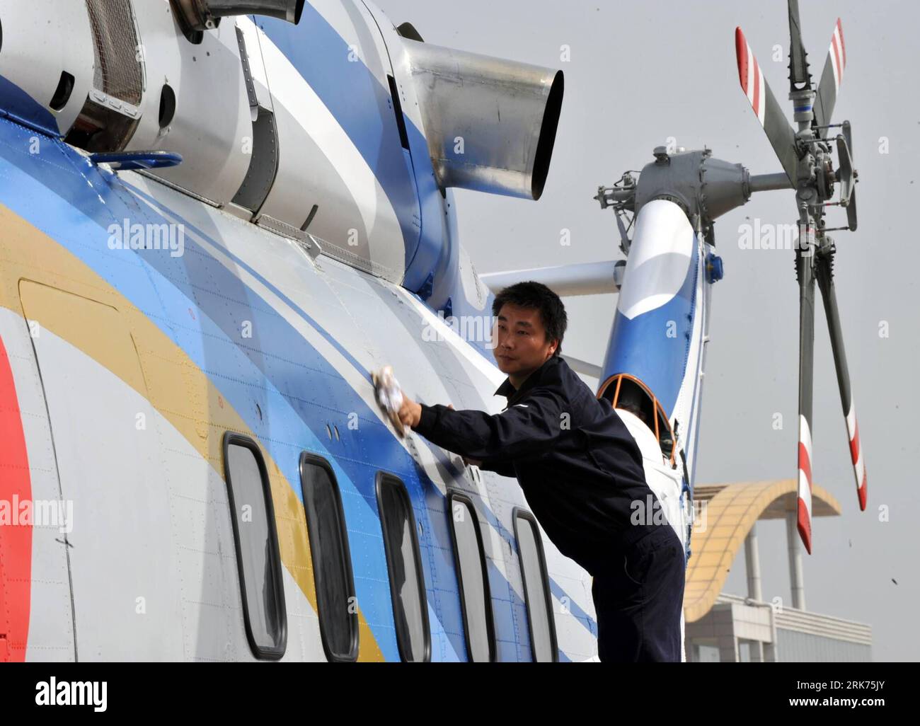 Bildnummer: 53864952  Datum: 18.03.2010  Copyright: imago/Xinhua (100318) -- JINGDEZHEN, March 18, 2010 (Xinhua) -- A ground crew member cleans the AC313, China s first domestically-made large civil helicopter, at Lumeng Airport in Jingdezhen City, east China s Jiangxi Province, March 18, 2010. The AC313 helicopter completed its maiden flight on Thursday.   It has a maximum range of 900 klometers. It was designed for a variety of uses, including transportation, search and rescue, fire fighting. (Xinhua/Zhang Wu)(zx) (1)CHINA-JIANGXI-LARGE CIVIL COPTER-TEST FLIGHT (CN) PUBLICATIONxNOTxINxCHN Wi Stockfoto