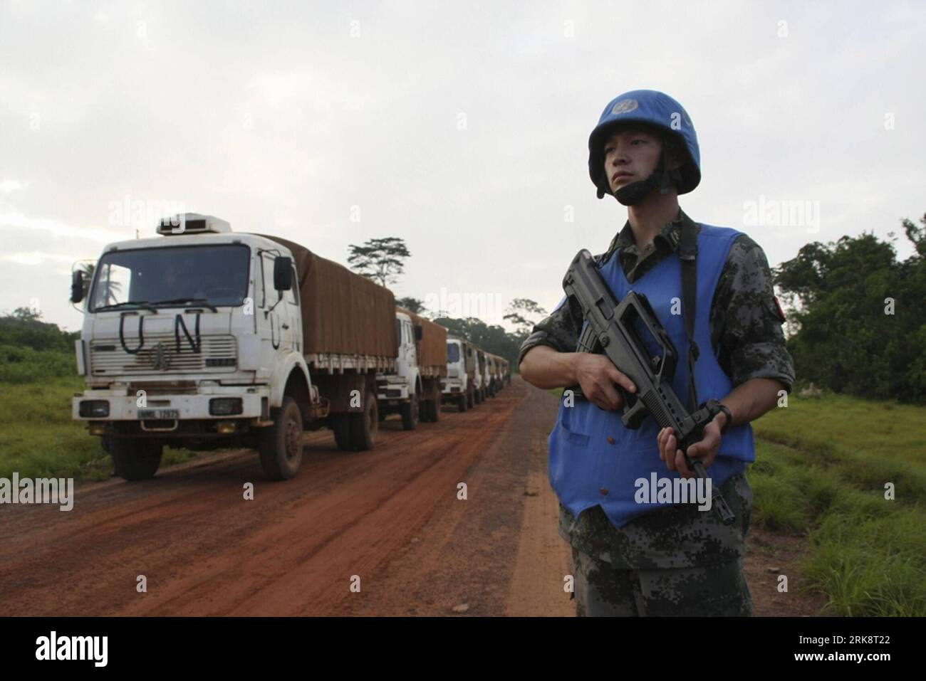 Ein Soldat wacht in der Nähe einer Autokolonne des Transportteams chinesischer Friedenstruppen in Liberia, 23. Mai 2010. Fünfundsechzig Soldaten und sechsundzwanzig Fahrzeuge der chinesischen Friedenstruppen verließen das Lager in Monrovia, der Hauptstadt Liberias, nach Zwedru. Es dauerte mehr als 20 Stunden, bis das Transportteam mehr als 300 Tonnen Material an die Zielorte lieferte. (Xinhua/Fan Deyin) (zhs) (1)LIBERIA-CHINA-PEACEKEEPER-TRANSPORT PUBLICATIONxNOTxINxCHN Stockfoto