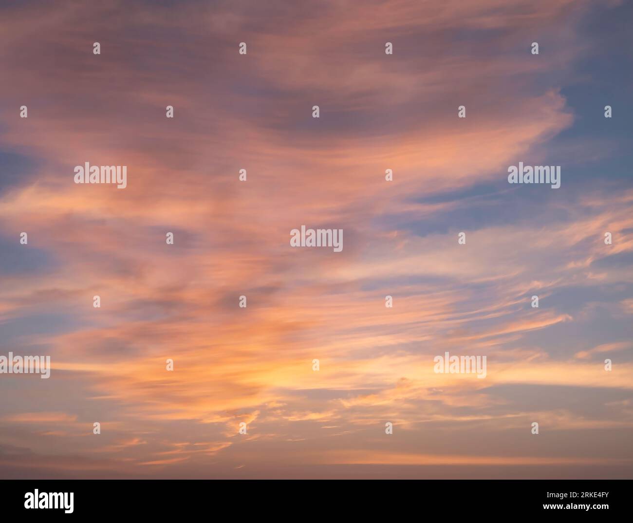 Ein fesselndes Foto fängt den ruhigen Abendhimmel ein, während die absteigende Sonne die Welt in ein warmes, goldenes Licht taucht. Die Farben des Himmels sind atemberaubend Stockfoto