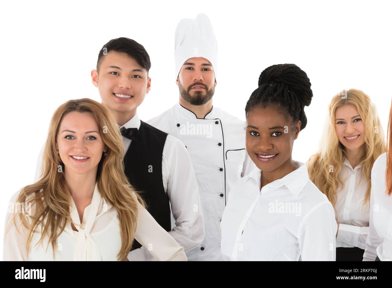 Portrait von zuversichtlich, das Personal im Restaurant gegen den weißen Hintergrund stehen Stockfoto