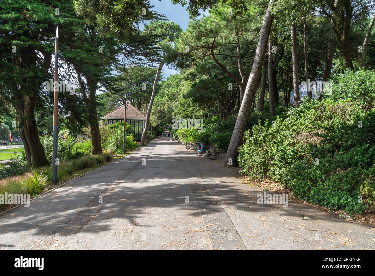 Pines Walk, Lower Gardens, Bournemouth, Großbritannien - 6. August 2023: Straße durch den Garten, vorbei am Pine Walk Bandstand. Stockfoto
