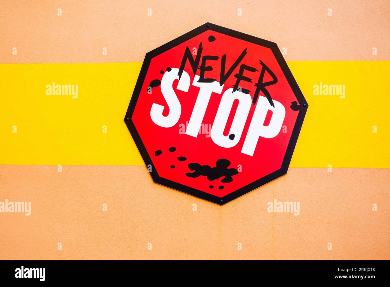 Signieren Sie an einer Wand mit dem Slogan „Never Stop“ Stockfoto