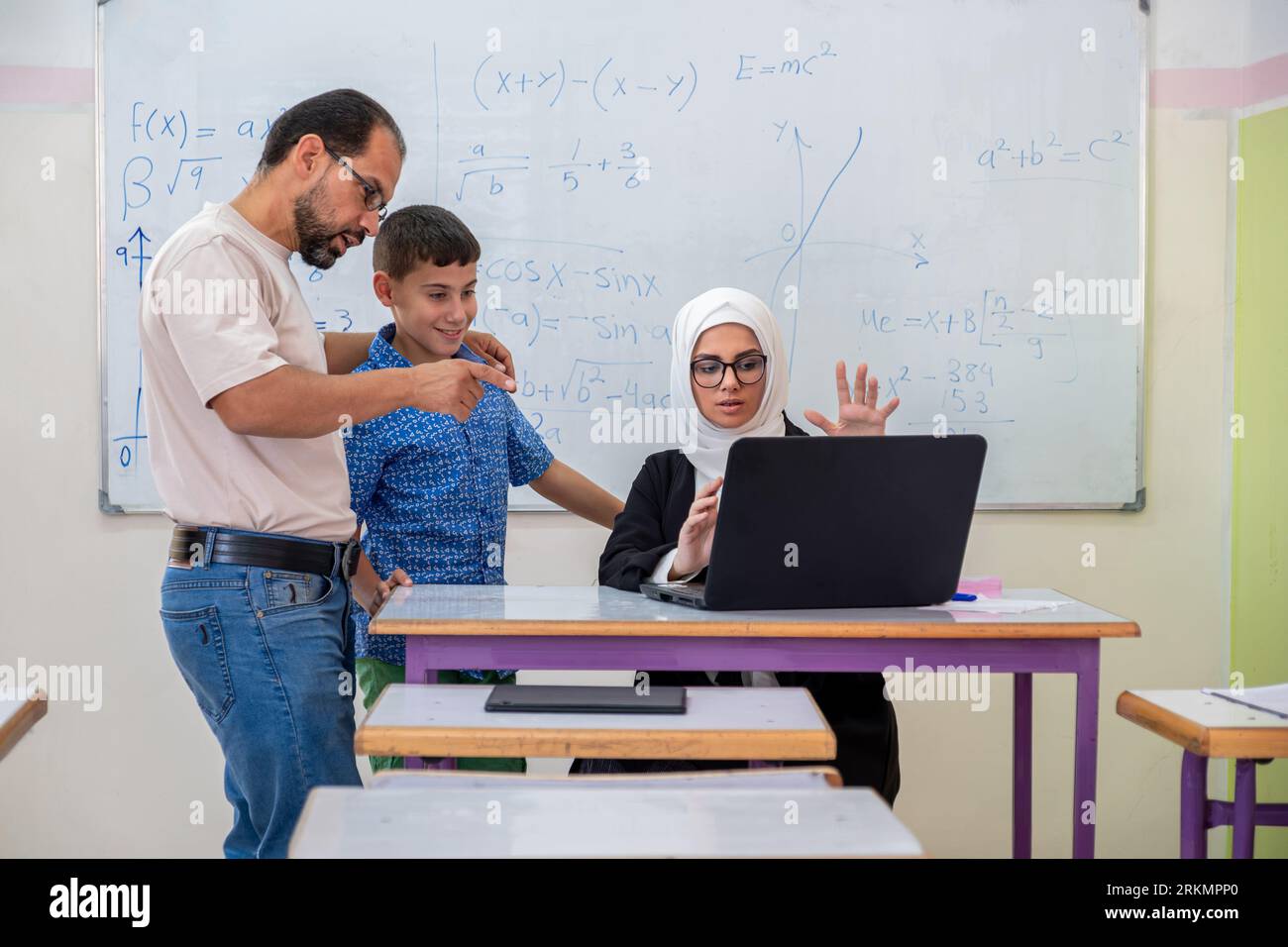 Mit dem Lehrer in der Schule über den akademischen Fortschritt von Here Son zu sprechen Stockfoto