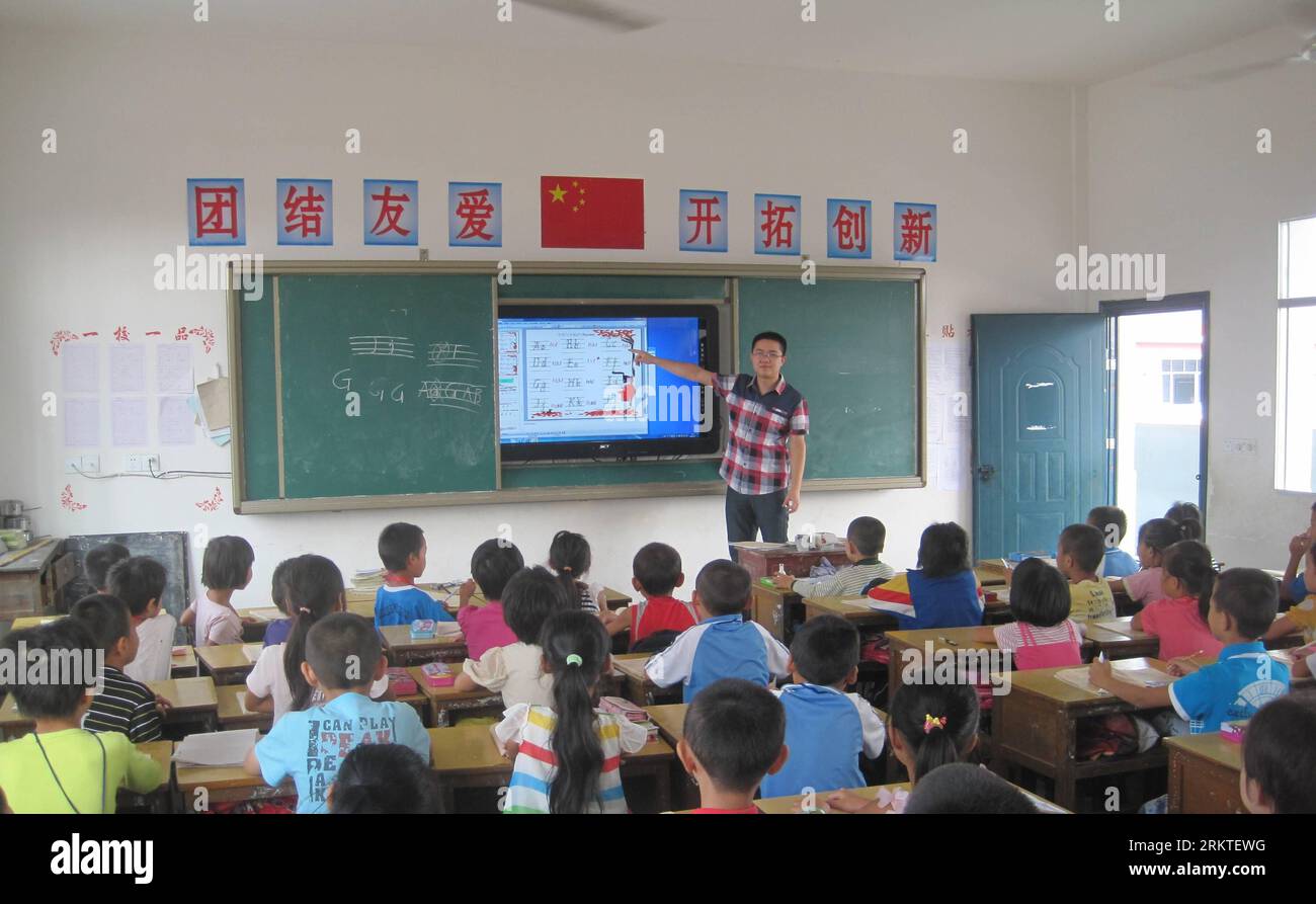 Bildnummer: 58462828 Datum: 07.09.2012 Copyright: imago/Xinhua NANCHANG, Sept. , 2012 - ein Englischlehrer mit dem englischen Namen Robin unterrichtet Schüler mit Hilfe von Internet und Multimedia-Einrichtungen in der Grundschule Xujiadu, einer ländlichen Schule in der ostchinesischen Provinz Jiangxi, 7. September 2012. Die Xujiadu-Grundschule ist einer der Nutznießer eines nationalen Projekts, das als Connecting Every Class bekannt ist, einem wichtigen Unterfangen des Bildungsministeriums, die Lücke zwischen Land und Stadt zu schließen. Aufgrund des Ungleichgewichts bei der wirtschaftlichen Entwicklung und der Verteilung der Bildungsressourcen sind die Studierenden in d Stockfoto