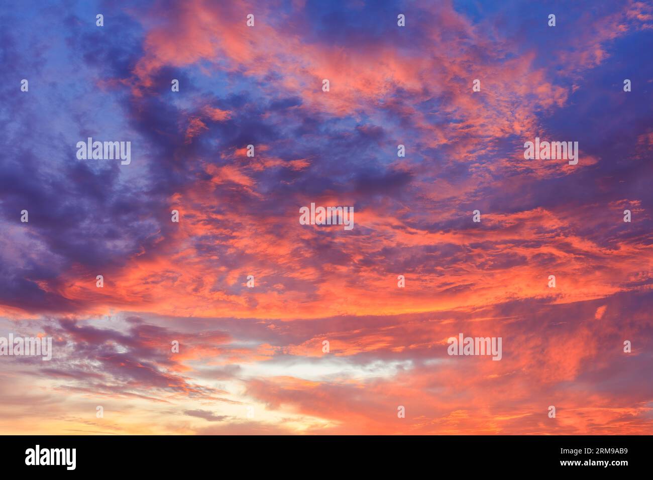 Feuer Sonnenaufgang Himmel hinter dem Hintergrund. Leuchtendes Feuer, dramatische Blau-, Rot- und Gelbtöne. Stockfoto