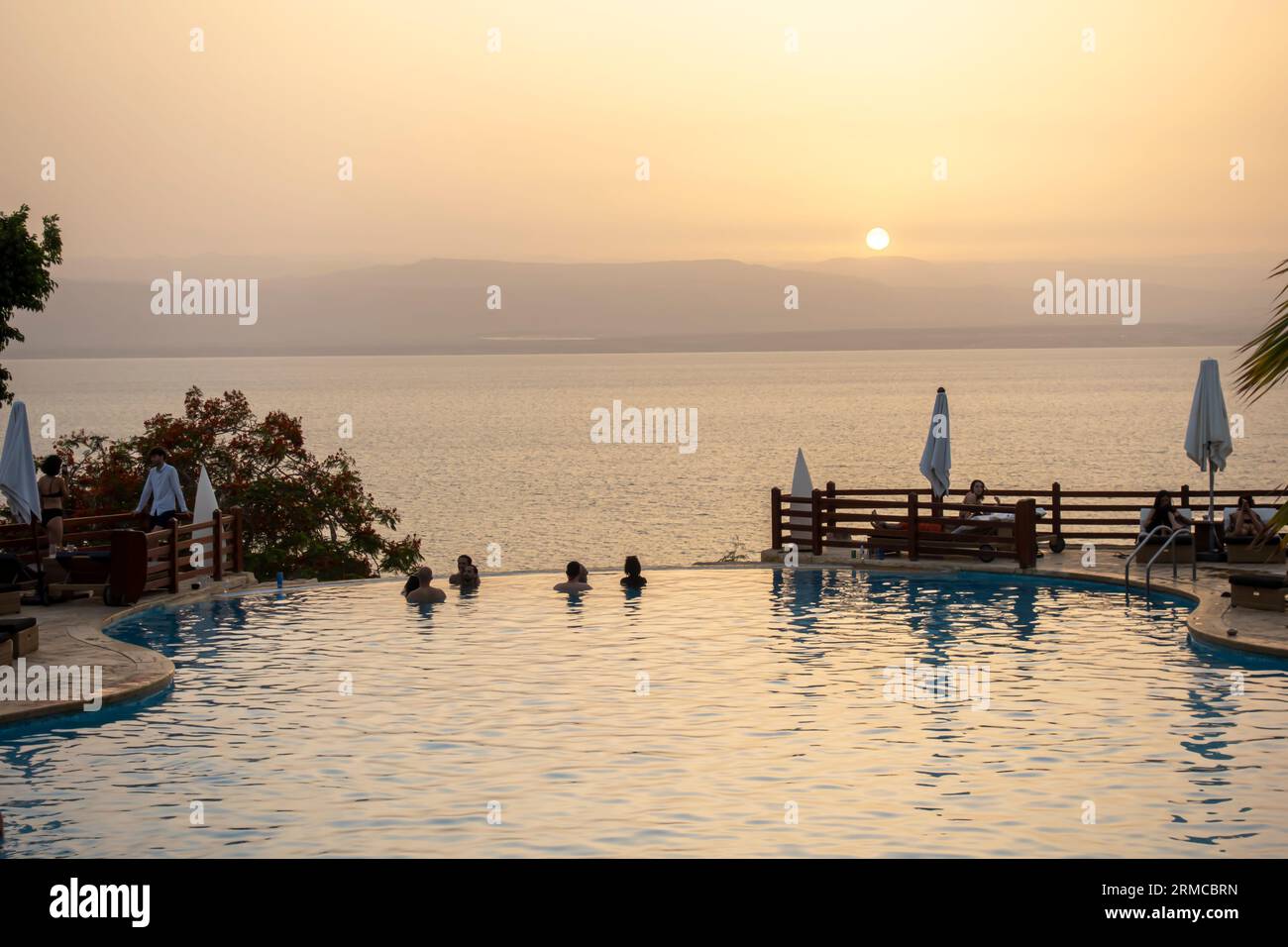 Jordan Resort Tourismus. Blick auf das Tote Meer in Jordanien. Swimmingpool am Toten Meer mit Blick auf das Meer, während Sonnenuntergang. Stockfoto