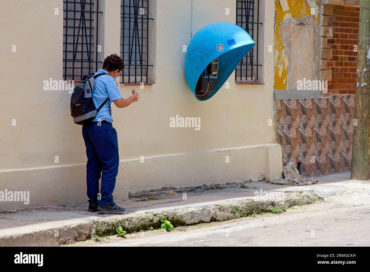 Havanna, Kuba, 2023, uniformierter Student mit einem Etecsa-Münztelefon Stockfoto