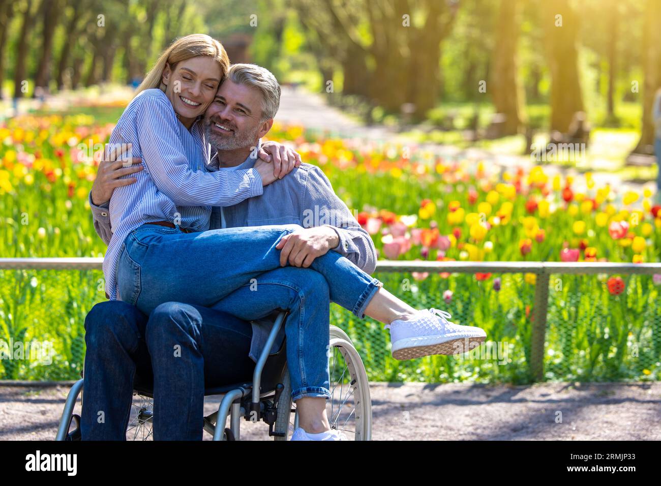 Ehefrau und ihr Mann mit Behinderung im Park. Stockfoto