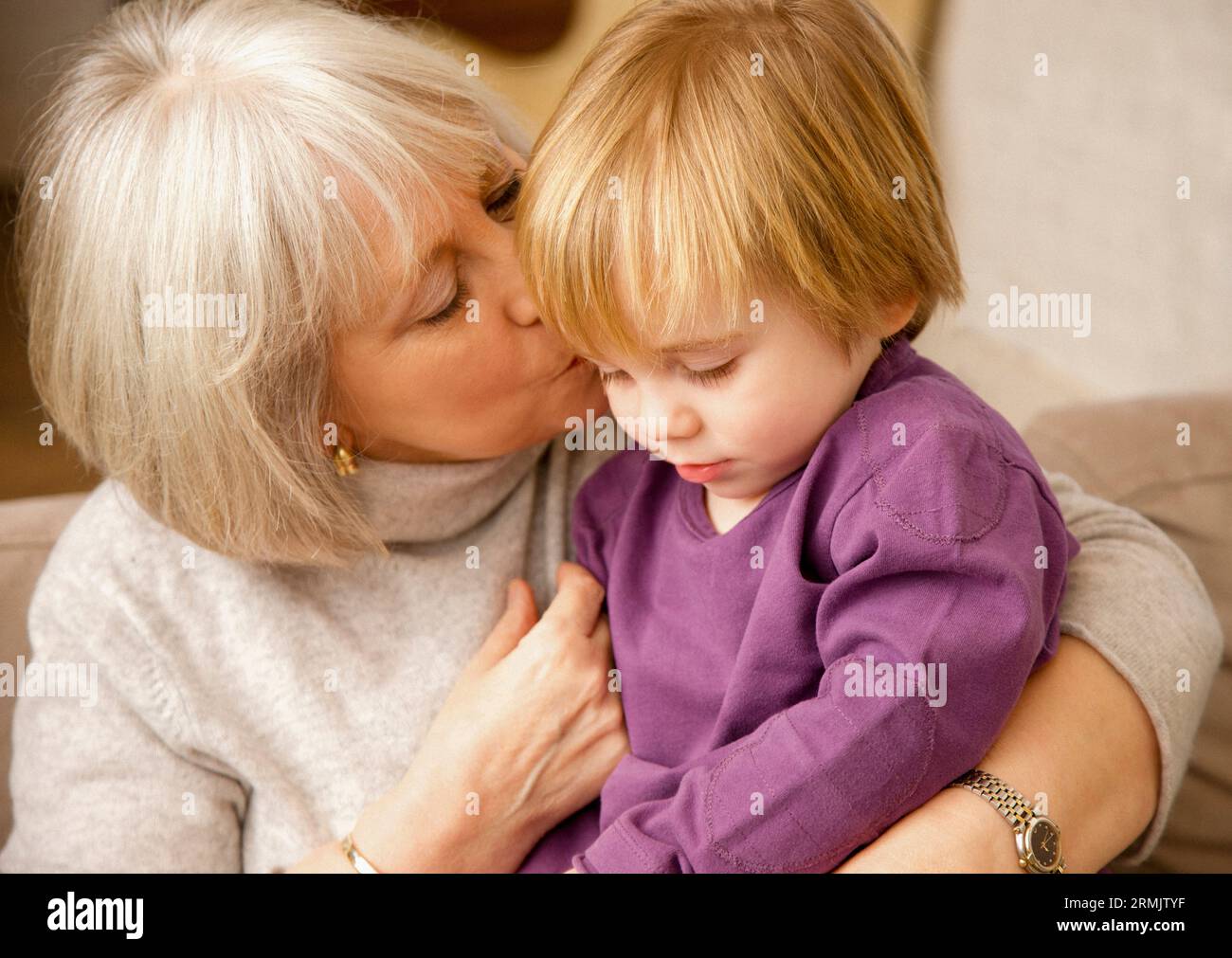 Großmutter küsst Enkelkind Stockfoto