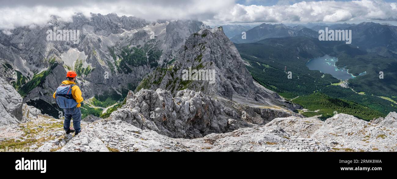 Panorama, Bergsteiger auf dem Gipfel des Waxensteins, Blick über den felsigen und schmalen Kamm des Waxensteins bis zum Hoellental mit Jubilaeumsgrat und Stockfoto