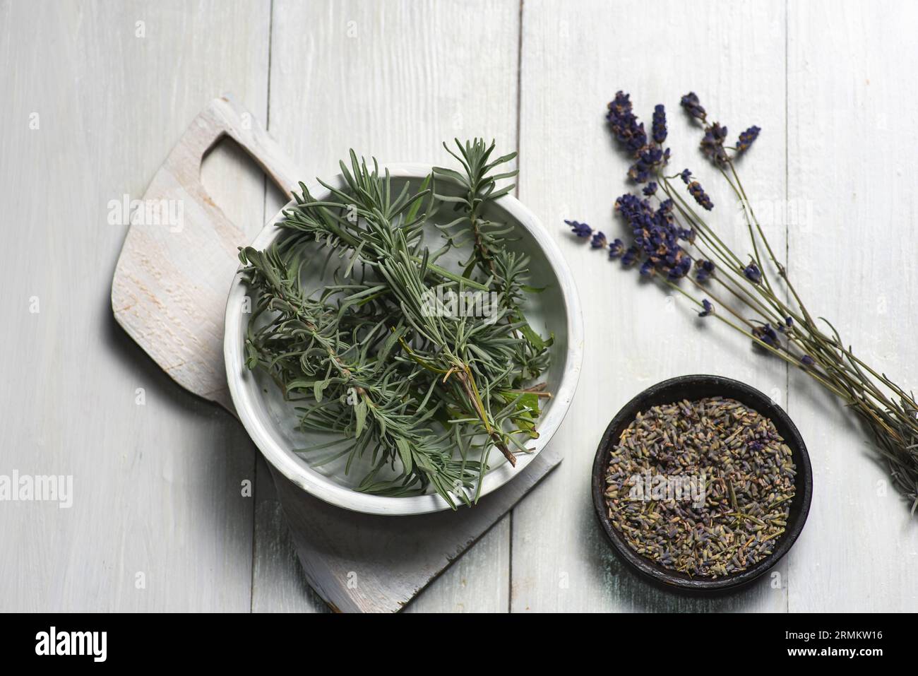 Herstellung von Blättern und Blüten der duftenden Lavendelpflanze zur Anwendung in Kosmetik, Alternativmedizin, Aromatherapie und Ernährung. Auf einem weißen Arbeitsauftrag Stockfoto