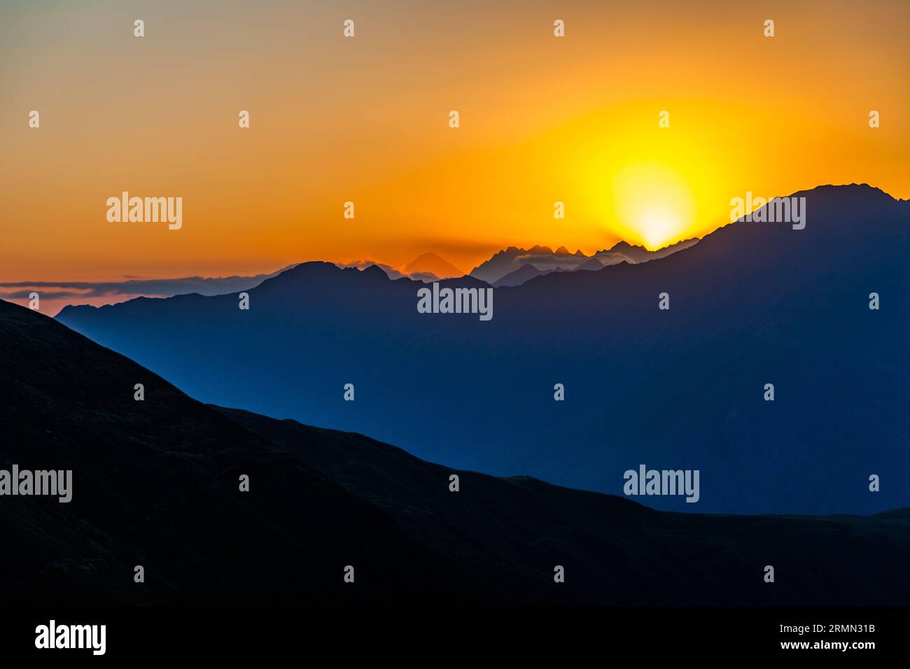 Auf der Khevsureti-Seite des Atsunta-Passes in Georgien. Bei Sonnenuntergang können Sie weit hinter dem Gebirge den Berg Kasbek sehen Stockfoto