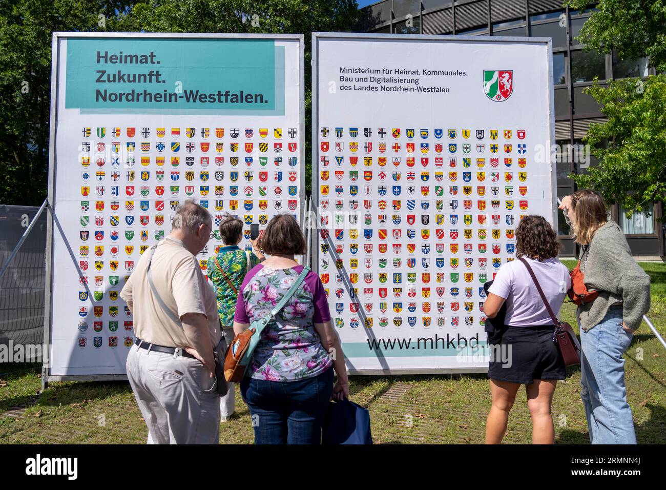 Symbolisches Bild von Haus, Plakatwand mit Wappen aller NRW-Gemeinden, Identifikation mit Haus, am Stand des Innenministeriums A Stockfoto