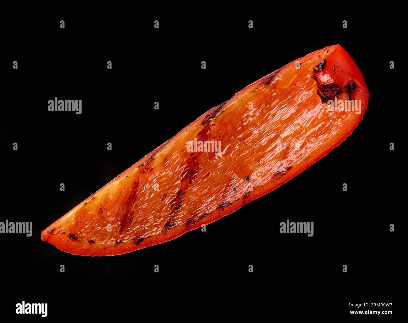 Gegrilltes saftiges rotes Paprikastück isoliert auf schwarzem Hintergrund, Draufsicht Stockfoto