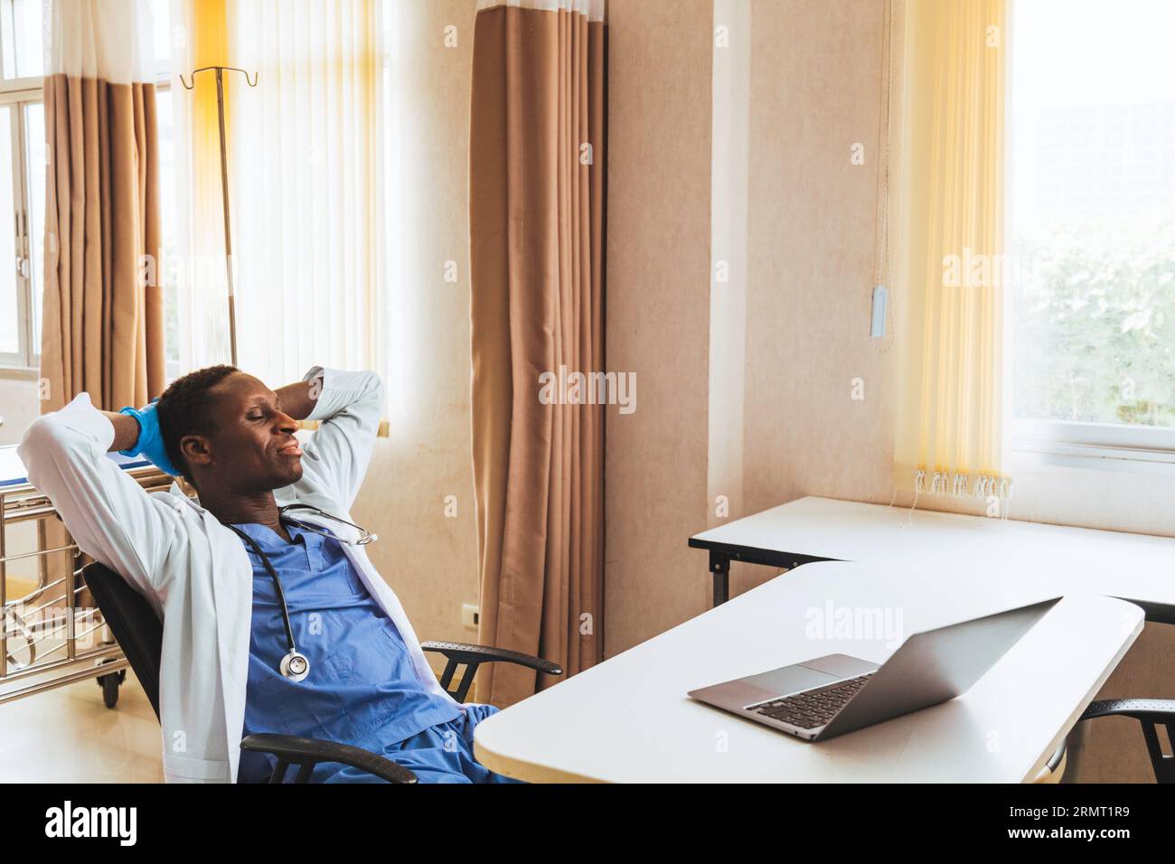 afroamerikaner junger Mann Arzt entspannte sich in einer Pause nach beendeter Beratung und Behandlung Patient in der Praxis im Krankenhaus. Stockfoto