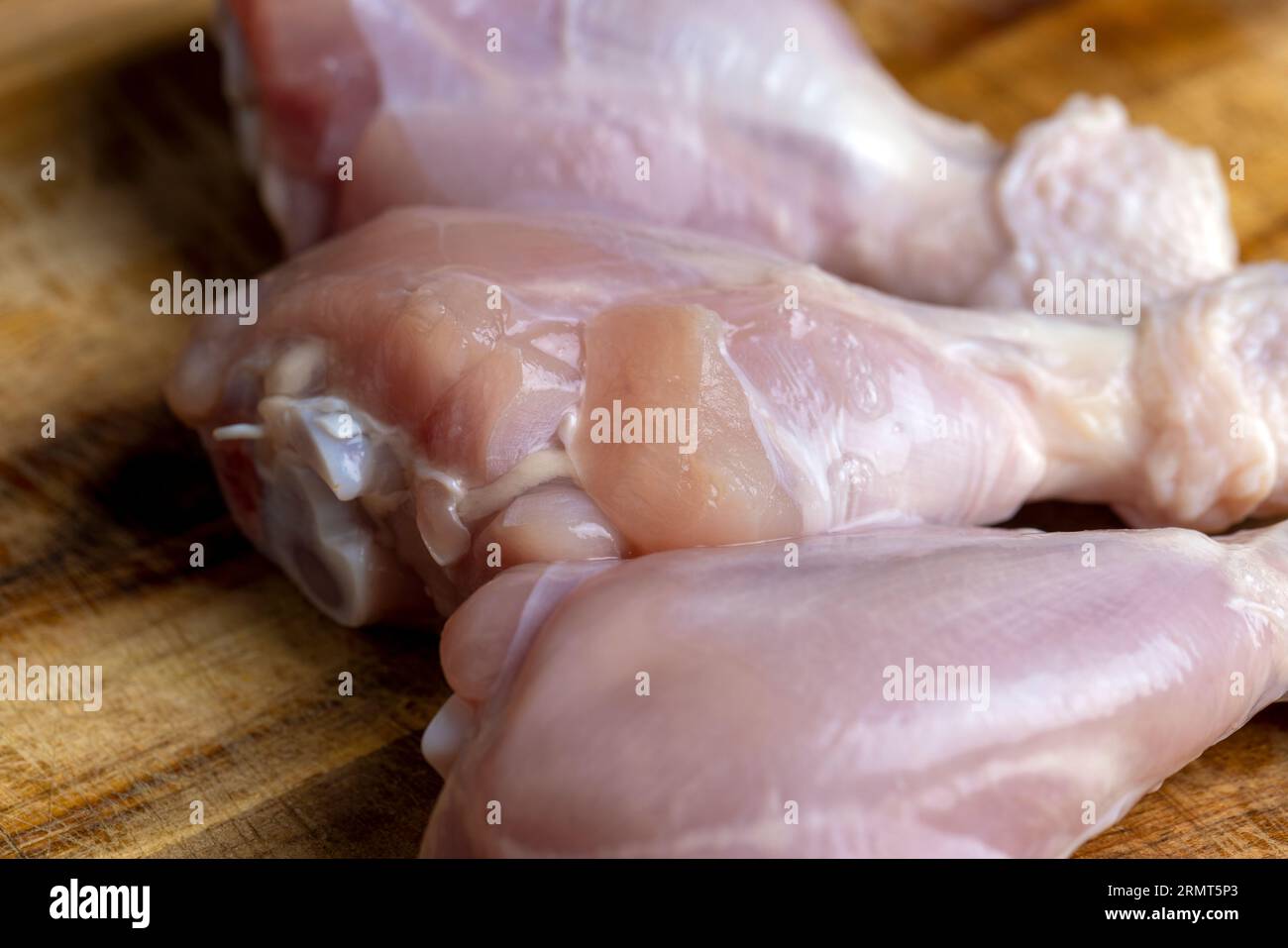 Frisch gewaschenes und gehäutetes Hühnerfleisch, Hühnerschenkel auf einem Brett liegen und zum Kochen bereit Stockfoto