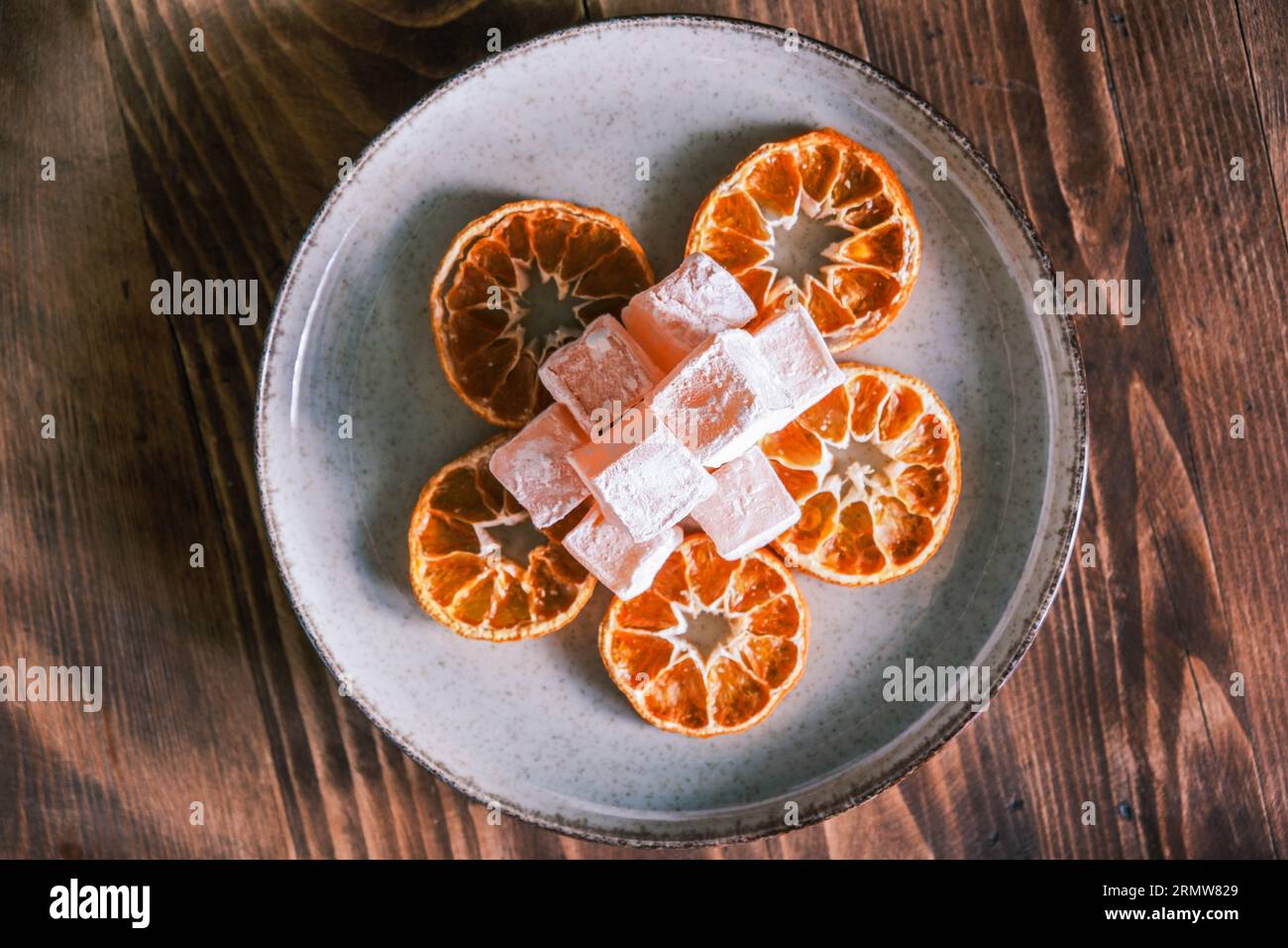 Getrocknete Mandarinen- oder Mandarinenscheiben mit türkischem Mandarinengeschmack auf einem Holztisch. Seferihisar lokale Aromen. Getrocknete Orange. Zitrusfrüchte Stockfoto