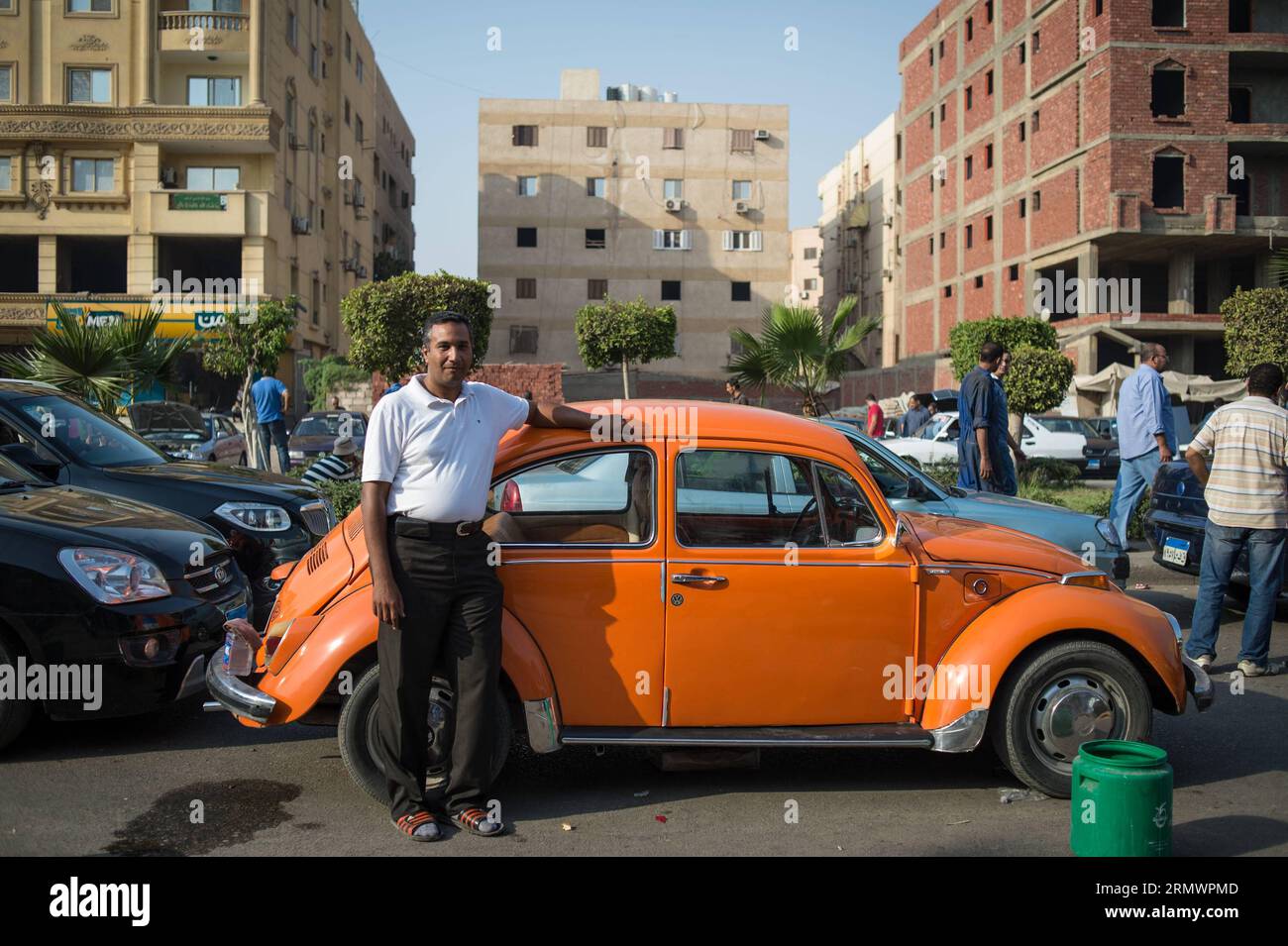 (141107) -- KAIRO, 7. November 2014 -- Sayyid Dahed, 38, zeigt seine orangefarbenen 1972 Volkswagen Käfer am 17. Oktober 2014 auf einem Gebrauchtwagenmarkt in Nasr City, östlicher Vorort in Kairo, Ägypten. Einige Autobesitzer, -Verkäufer, -Käufer und -Händler auf dem riesigen Gebrauchtwagenmarkt beschwerten sich über eine Rezession auf dem Markt aufgrund der jüngsten Preiserhöhungen infolge der jüngsten Kürzungen der staatlichen Energiezuschüsse, die die Preise für Kraftstoff, Erdgas, Strom und andere erhöhten. die Argumentation, die wirtschaftlichen Reformpläne des Landes hätten sich auf den Second-Hand-Markt ausgewirkt. ) ÄGYPTEN-KAIRO-GEBRAUCHTWAGENMARKT-FEATURE PANXCHAOYUE Stockfoto