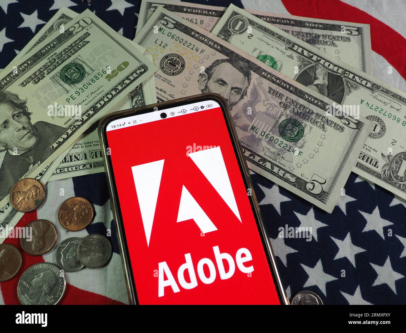 In dieser Abbildung wird das Logo von Adobe, Inc. Auf einem Smartphone angezeigt Stockfoto