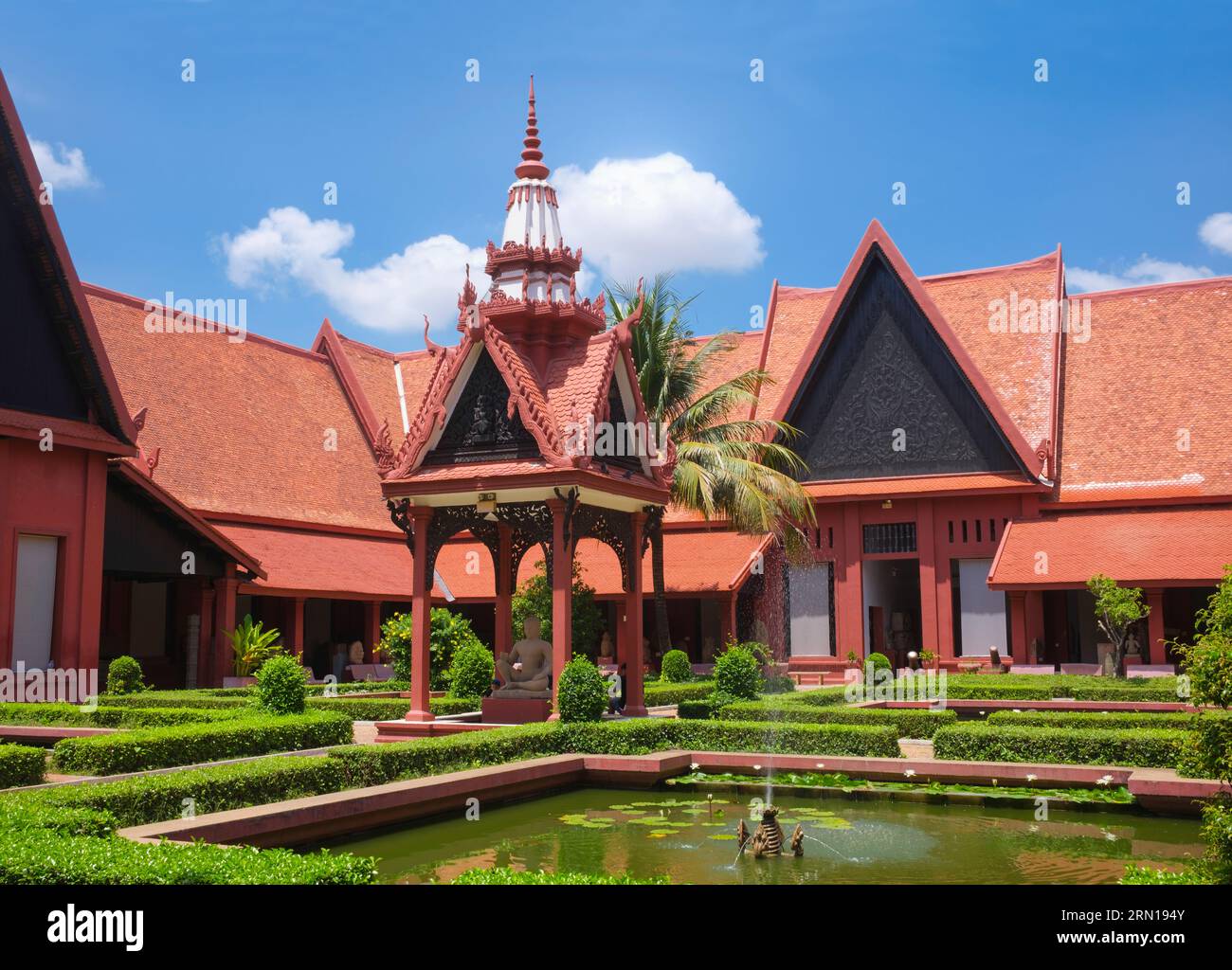 Kambodscha: Nationalmuseum von Kambodscha, Phnom Penh, entworfen von George Groslier (1887–1945). Das Nationalmuseum befindet sich in einem roten Pavillon aus dem Jahr 1918 und beherbergt eine Sammlung von Khmer-Kunst, darunter einige der schönsten Stücke der Welt. Zu den Exponaten gehören eine Vishnu-Statue aus dem 6. Jahrhundert, eine Shiva-Statue aus dem 9. Jahrhundert und der berühmte, in meditativer Pose geformte Kopf von Jayavarman VII. Besonders beeindruckend ist die beschädigte Büste eines liegenden Vishnu, der einst Teil einer massiven Bronzestatue war, die im westlichen Mebon-Tempel in Angkor gefunden wurde. Stockfoto