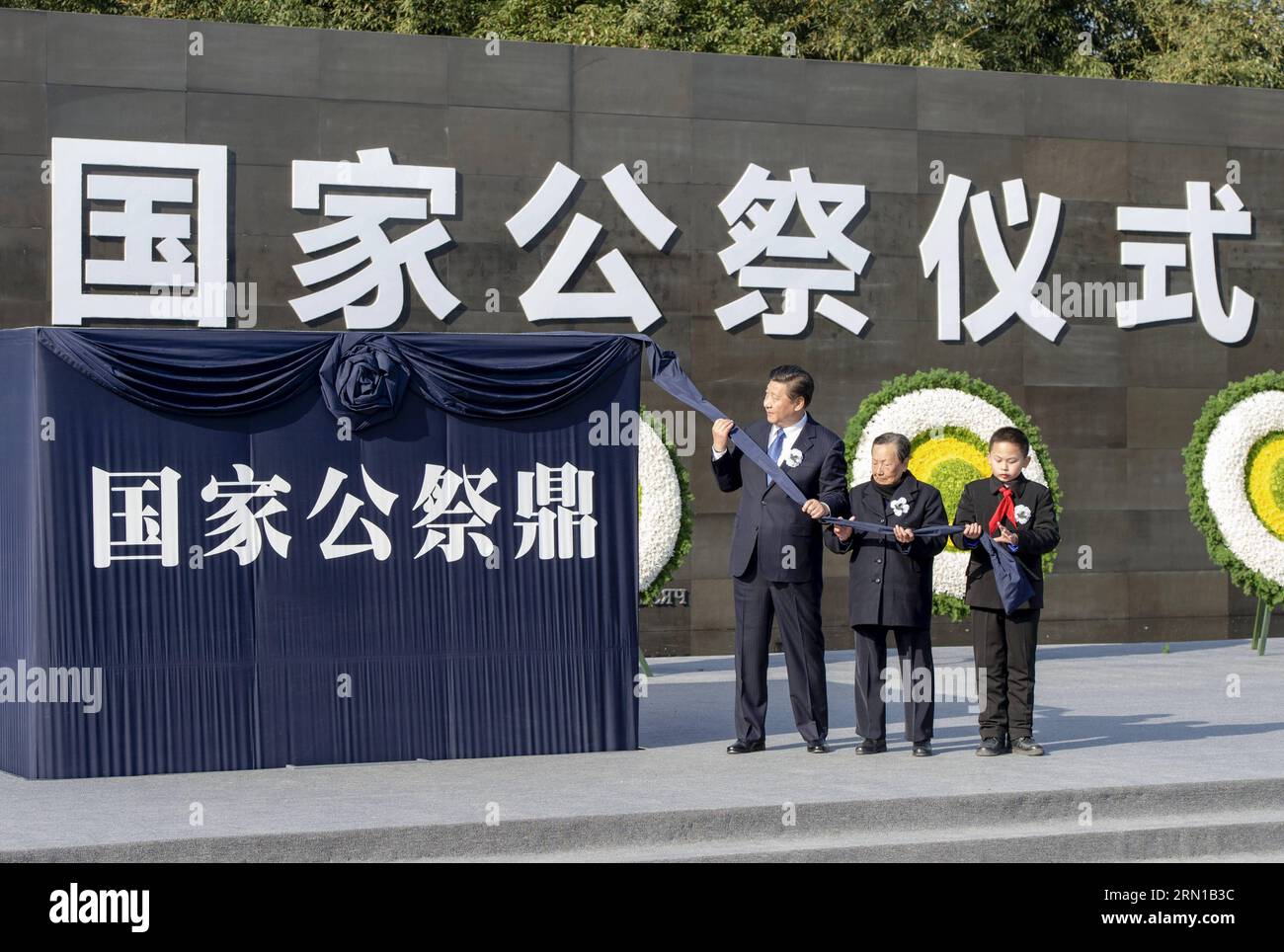 Der chinesische Präsident Xi Jinping (L) widmet zusammen mit Xia Shuqin (C), einem 85-jährigen Überlebenden des Massakers, und einem Schulkind eine Dingform, eine Art alten chinesischen Kessel, der die Macht und den Wohlstand des Staates symbolisiert. an die Opfer des Massakers von Nanjing während der Staatszeremonie für Chinas ersten Nationalen Gedenktag für die Opfer des Massakers von Nanjing in der Gedenkhalle für die Opfer des Massakers in Nanjing, Ostchinesische Provinz Jiangsu, 13. Dezember 2014. ) (wf) CHINA-NANJING MASSAKER OPFER-STAATLICHE GEDENKZEREMONIE-XI JINPING(CN) MaxZhancheng PUBLICATIONxNOTxINxCHN Chinesischer Präsident Xi Jinping l zusammen mit Xia Stockfoto