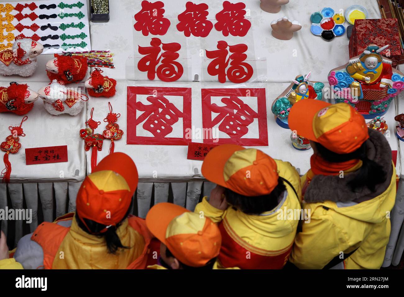 (150215) -- PEKING, 15. Februar 2015 -- Dorfbewohner sehen Papierschneidearbeiten mit chinesischem Charakter Fu, was viel Glück bedeutet, während einer Messe im Dorf Dagao, Bezirk Tongzhou, Peking, Hauptstadt von China, 15. Februar, 2015. mehr als 20.000 Kunstwerke, die von 60 Volkskünstlern aus Peking geschaffen wurden, wurden an die Dorfbewohner geschickt, um das bevorstehende Frühlingsfest zu begrüßen, das am 19. Februar dieses Jahres stattfindet. )(wyo) CHINA-BEIJING-TEMPLE FAIR-FOLK ART (CN) GaoxJing PUBLICATIONxNOTxINxCHN Peking 15. Februar 2015 Dorfbewohner sehen Papierschneidearbeiten mit chinesischem Charakter Fu Bedeutung viel Glück während einer Messe im Dorf Dagao Tong ZH Stockfoto