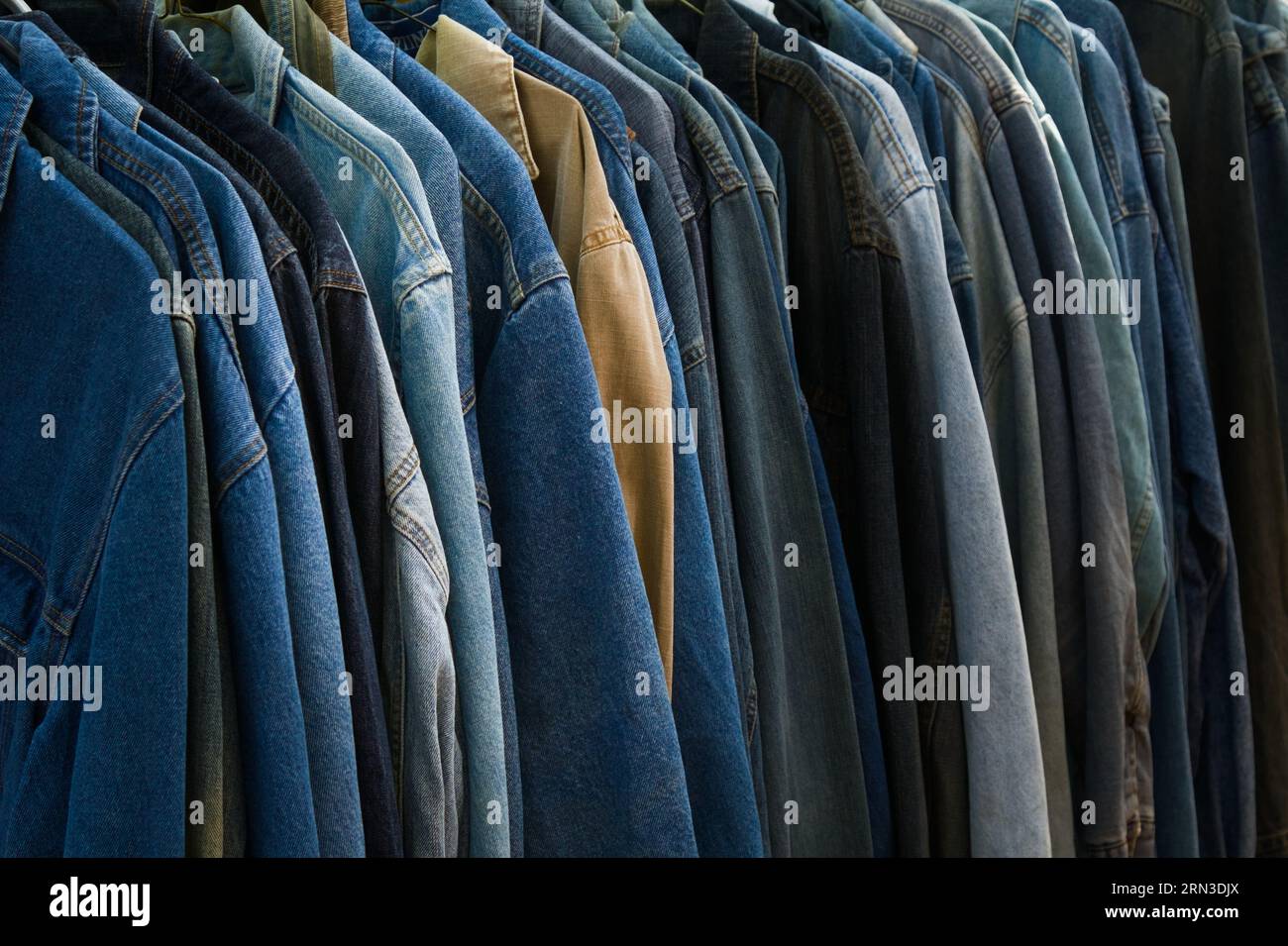 Row of Vintage Denim Shirts Hanging on A Rail for Sale, England, Großbritannien Stockfoto